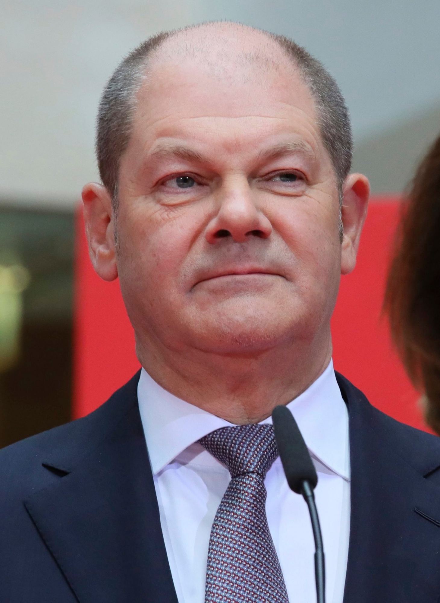 The designated finance minister Olaf Scholz stands on the podium when the Social Democratic Party present their ministers in the new German government at the party's headquarters in Berlin Friday, March 9, 2018. (Michael Kappeler/dpa via AP) Germany Politics