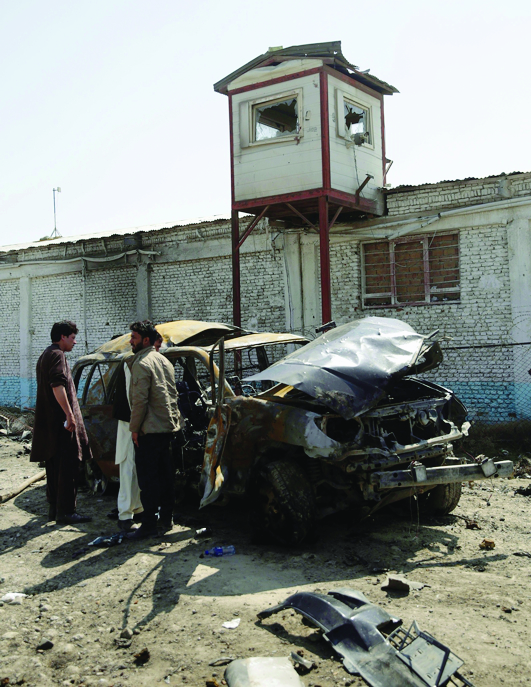 Officials inspect the site of a suicide car bomb in Kabul, Saturday, March 17, 2018. An official with Afghanistan's Interior Ministry says a suicide car bomber targeting a British security company in the capital Kabul has killed and injured civilians. (AP Photo/Massoud Hossaini) Afghanistan