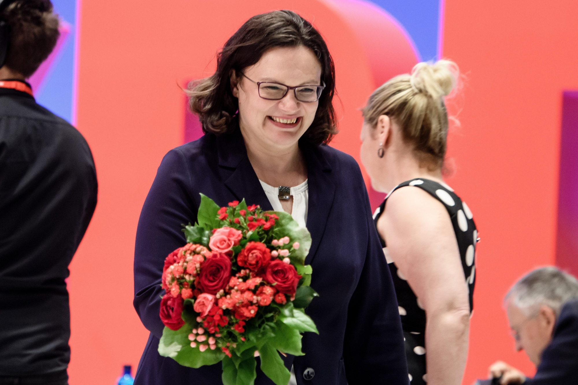 epa06685415 New chairman of the Social Democratic Party (SPD) Andrea Nahles holds flowers during an extraordinary Social Democrats (SPD) party convention in Wiesbaden, Germany, 22 April 2018. The SPD delegates gather in Wiesbaden to vote for their next party leader electing Nahles as the first woman into this party office.  EPA/CLEMENS BILAN GERMANY PARTIES SPD