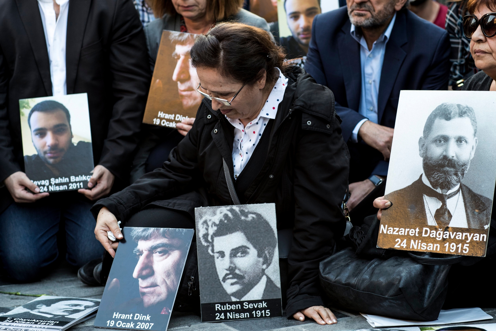 epa06689764 Rakel Dink (C) the wife of slain Armenian Journaist Hrant Dink holds pictures of victims as she attends a memorial to mark the 103rd anniversary of the mass killings of Armenians in the Ottoman Empire, in Istanbul, Turkey, 24 April 2018. The anniversary is marked on 24 April 2018, to mark the beginning of events that led to the systematic extermination of 1.5 million Armenians during World War I. Most scholars recognize the mass killings as genocide, but the Turkish government resists the label and insists the number of deaths is smaller.  EPA/SEDAT SUNA TURKEY ARMENIA DEMONSTRATION