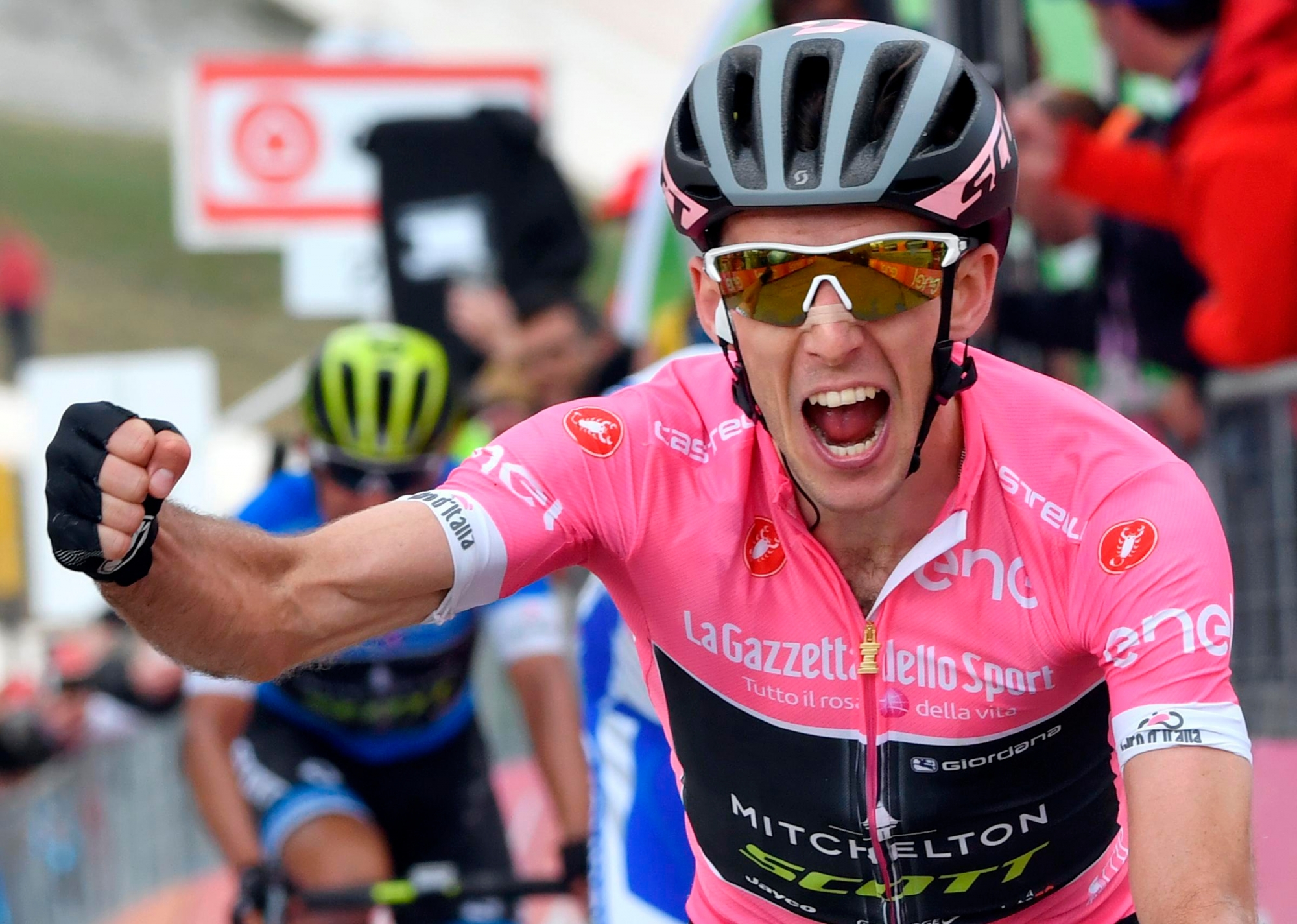 Britain's Simon Yates celebrates as he crosses the finish line to win the 9th stage of the Giro dÇÄÙItalia cycling race from Pesco Sannita to Campo Imperatore, Italy, Saturday, May 13, 2018.  Simon Yates cemented his position as overall leader of the Giro d'Italia by winning the ninth stage on Sunday but it was a bad day for British compatriot Chris Froome, who lost more than a minute in the general classification. (Daniel Dal Zennaro/ANSA via AP) Italy Giro Cycling