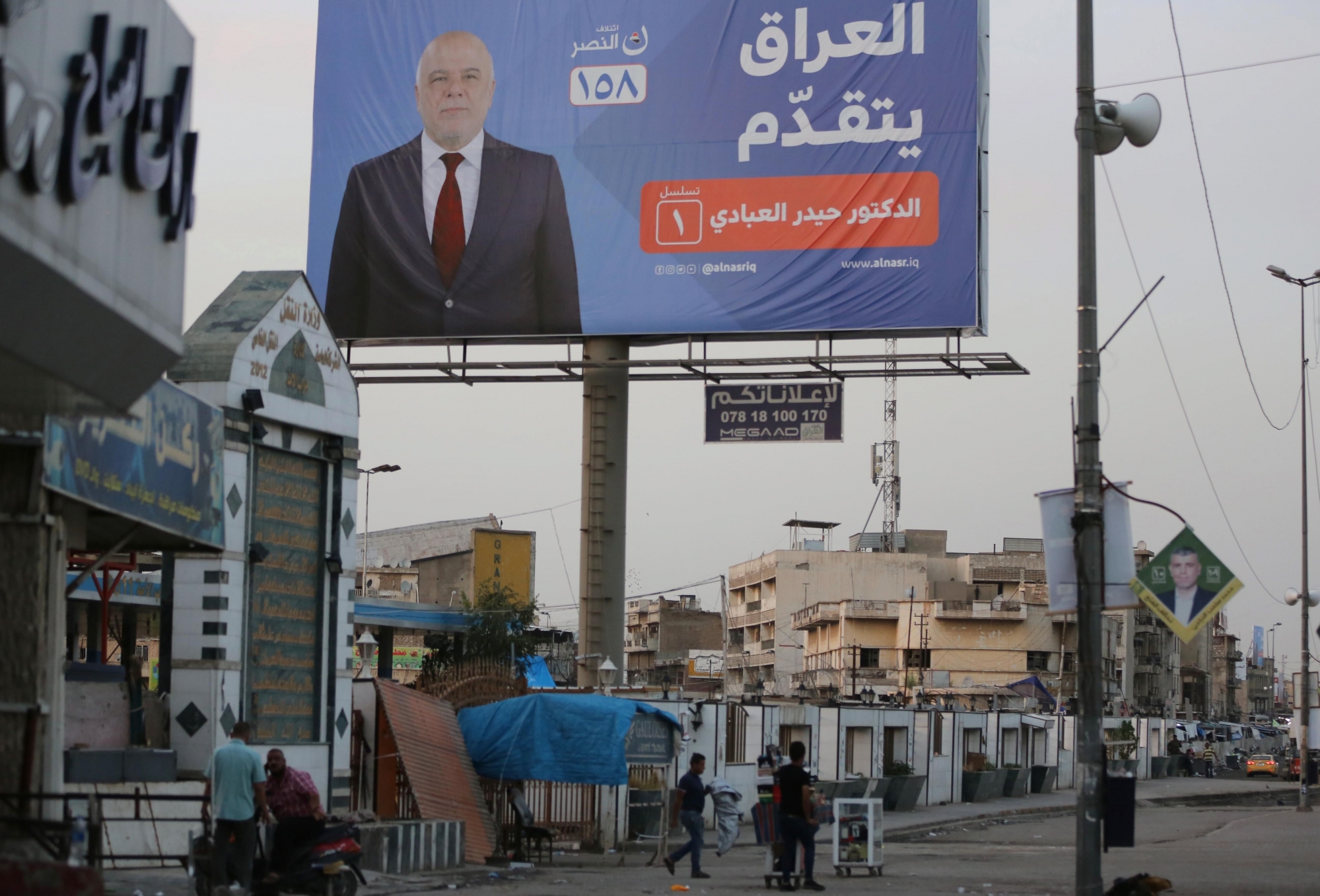 In this Thursday, May 3, 2018 photo, campaign poster of Iraqi Prime Minister Haider al-Abadi in seen in Baghdad, Iraq. Four years in office, Iraqi Prime Minister Haidar al-Abadi has racked up a list of achievements to make most politicians green with envy. He prevailed over an Islamic State insurgency that at its peak controlled one-third of the country. He steered Iraq's economy through a collapse in global oil prices. And he foiled a Kurdish bid for independence. (AP Photo/Karim Kadim) IRAQ ELECTIONS