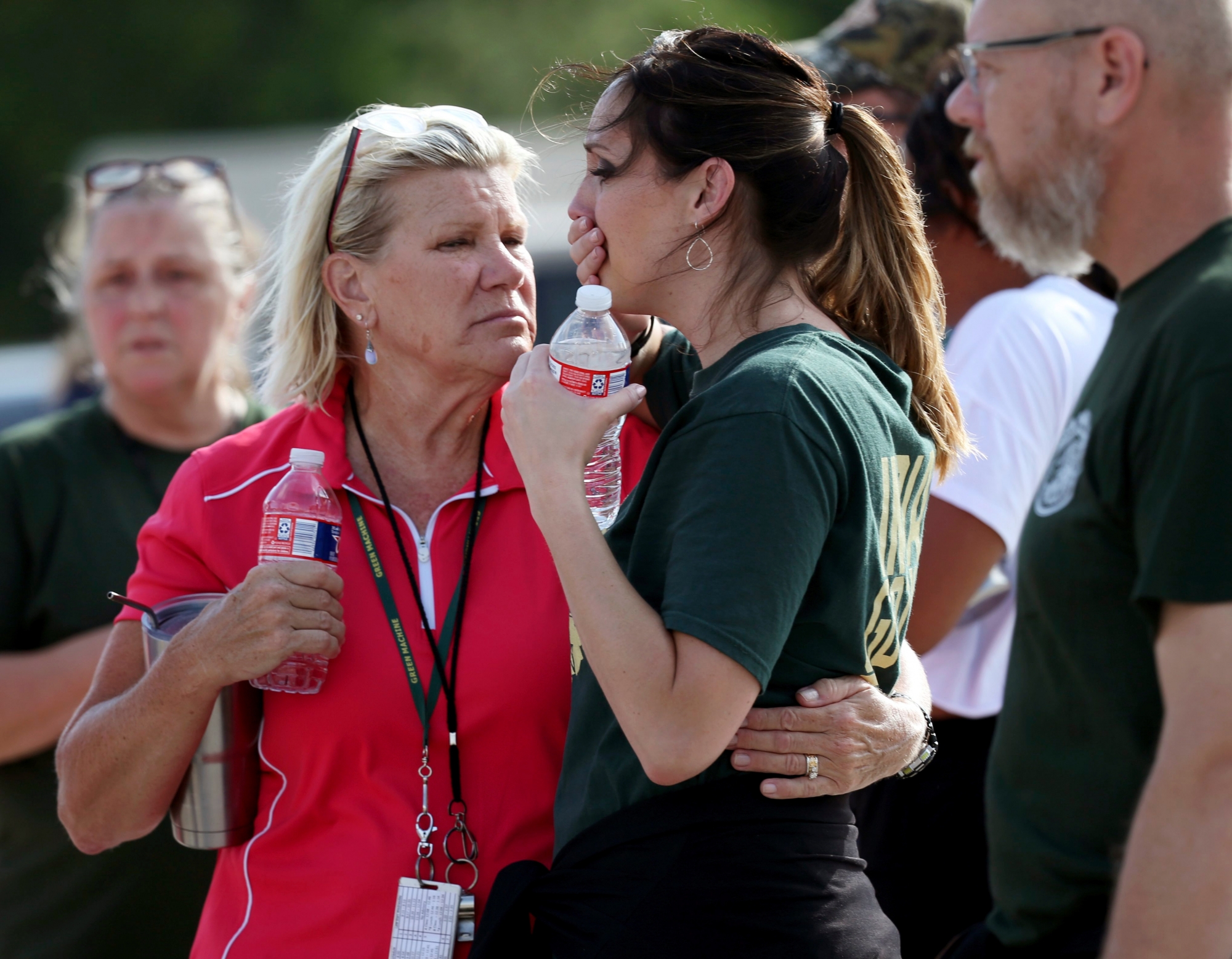 Santa Fe High School staff react as they gather in the parking lot of a gas station following a shooting at the school in Santa Fe, Texas, on Friday, May 18, 2018.   (Jennifer Reynolds/The Galveston County Daily News via AP) School Shooting Texas