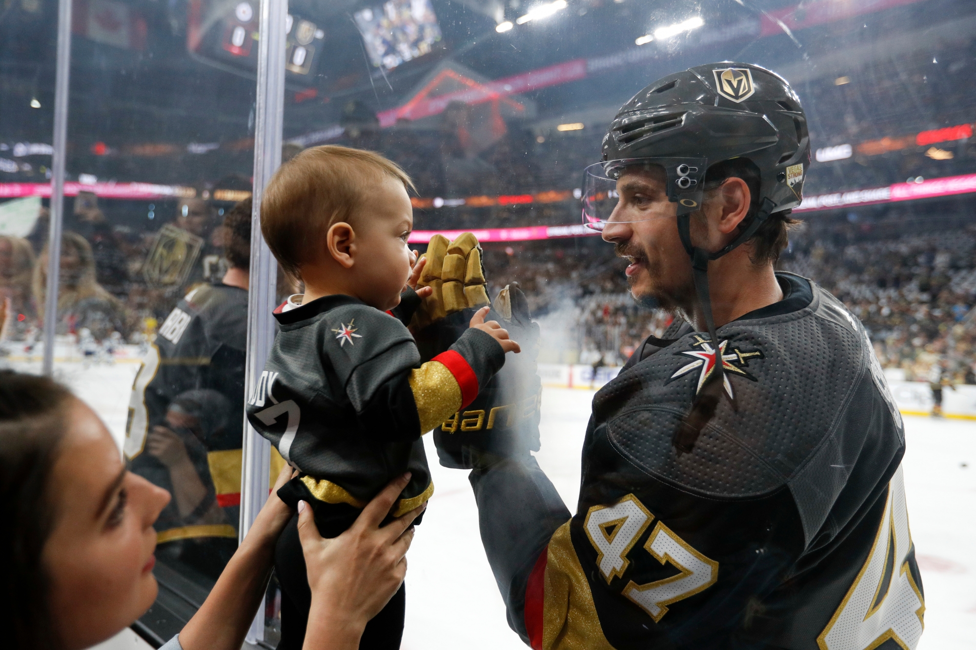 Vegas Golden Knights defenseman Luca Sbisa greets a young fan before Game 4 of the team's NHL hockey Western Conference finals against the Winnipeg Jets, Friday, May 18, 2018, in Las Vegas. (AP Photo/John Locher)r JETS GOLDEN KNIGHTS HOCKEY