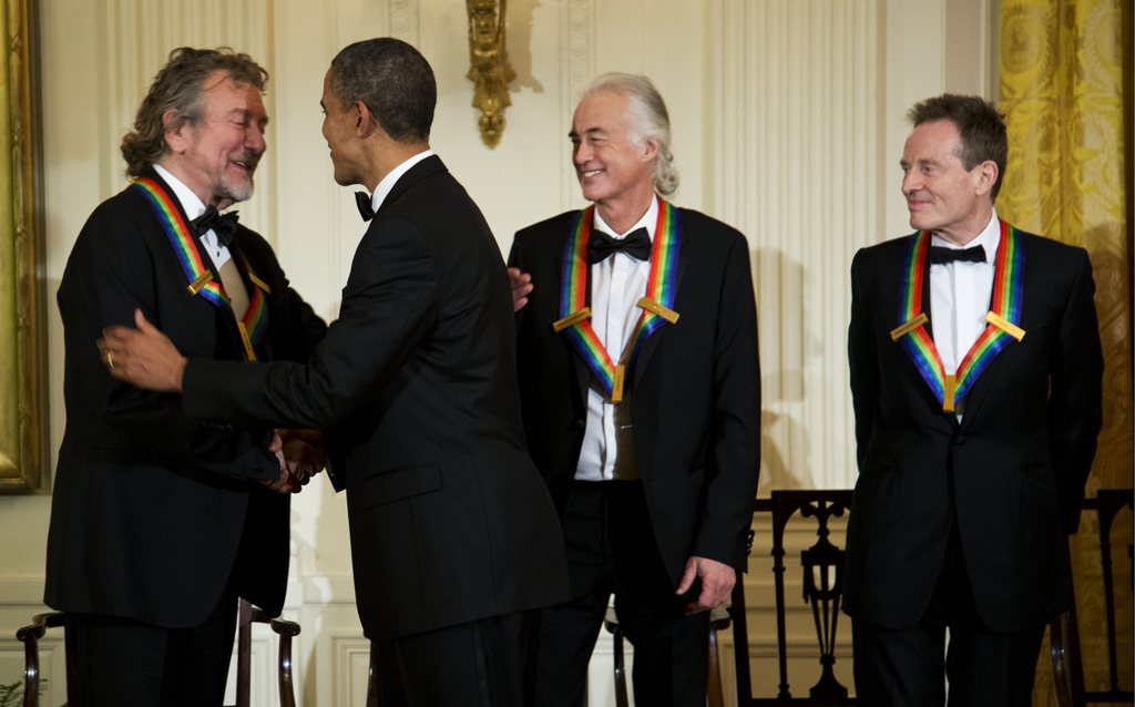 President Barack Obama shakes hands with the 2012 Kennedy Center Honors recipients, from left, rock band Led Zeppelin singer Robert Plant, guitarist Jimmy Page, and keyboardist/bassist John Paul Jones, during a reception hosted by President Barack Obama and first lady Michelle Obama for the honorees in the East Room of the White House in Washington, Sunday, Dec. 2, 2012. While Led Zeppelin is being honored as a band, surviving members John Paul Jones, Jimmy Page, and Robert Plant, each received the Kennedy Center Honors. (AP Photo/Manuel Balce Ceneta)