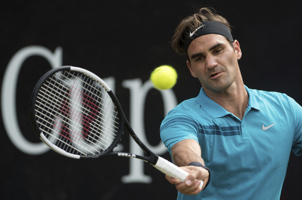 Roger Federer returns the ball to Nick Kyrgios in their semifinal tennis match during the ATP Mercedes Cup in Stuttgart, Saturday June 16, 2018.(Marijan Murat/dpa via AP)