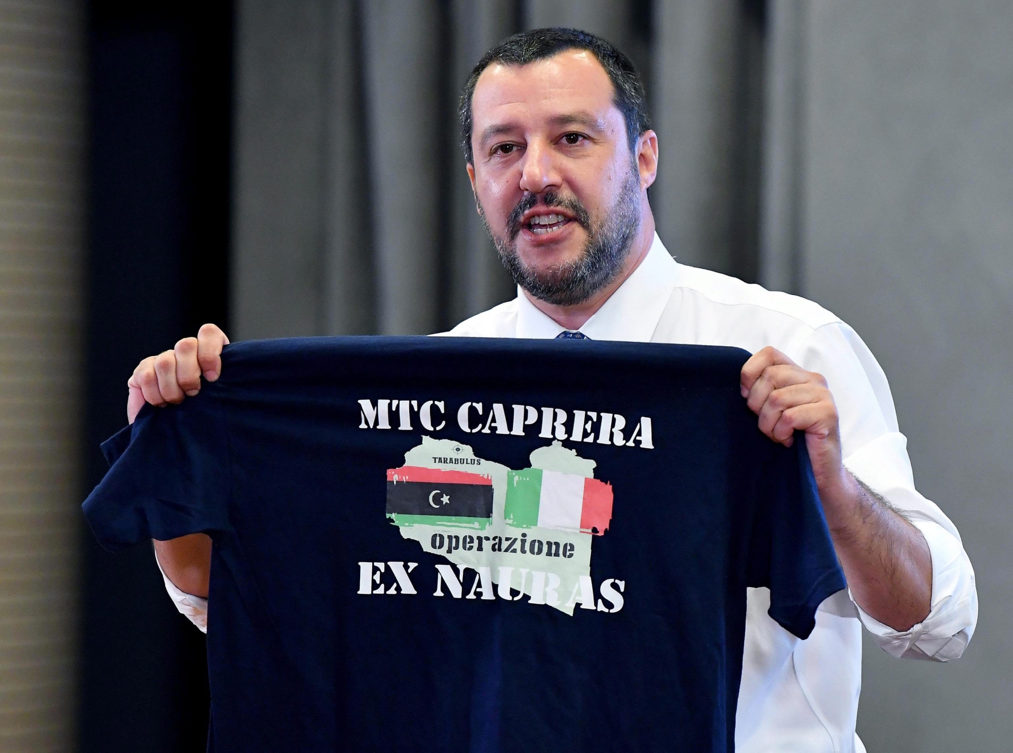 epa06839632 Italian Interior Minister Matteo Salvini shows a T-shirt of Italian Navy with Libyan and Italian flags during a press conference at Viminale palace in Rome, 25 June 2018. According to reports, earlier in the day Salvini visited Tripolis and called to create migrant reception centers in Libya.  EPA/ETTORE FERRARI ITALY GOVERNMENT MIGRATION