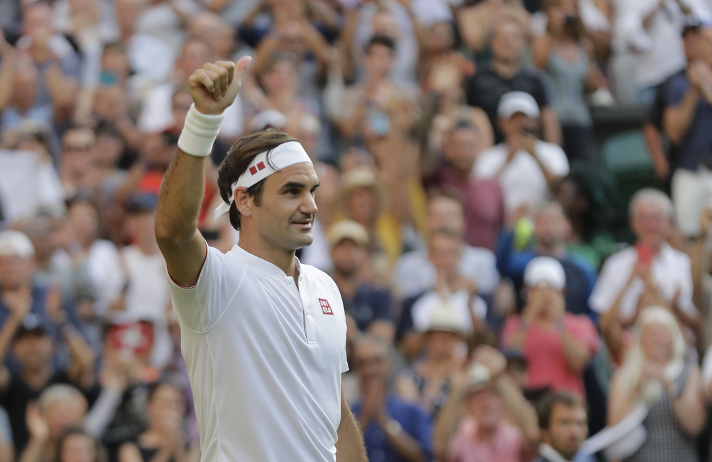 Switzerland's Roger Federer gives a thumbs up after winning his men's singles match against Germany's Jan-Lennard Struff, on the fifth day of the Wimbledon Tennis Championships in London, Friday July 6, 2018. (AP Photo/Ben Curtis)