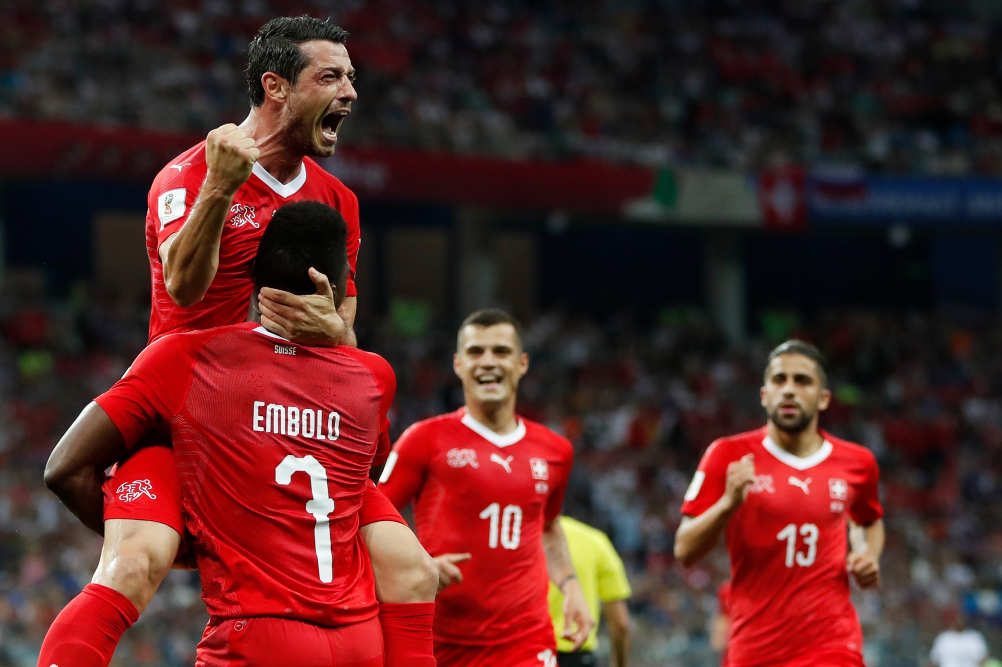 Switzerland's Blerim Dzemaili, top, celebrates with his teammates, from left, Breel Embolo, Granit Xhaka and Ricardo Rodriguez after scoring his side's first goal during the group E match between Switzerland and Costa Rica, at the 2018 soccer World Cup in the Nizhny Novgorod Stadium in Nizhny Novgorod , Russia, Wednesday, June 27, 2018. (AP Photo/Natasha Pisarenko) Russia Soccer WCup Switzerland Costa Rica