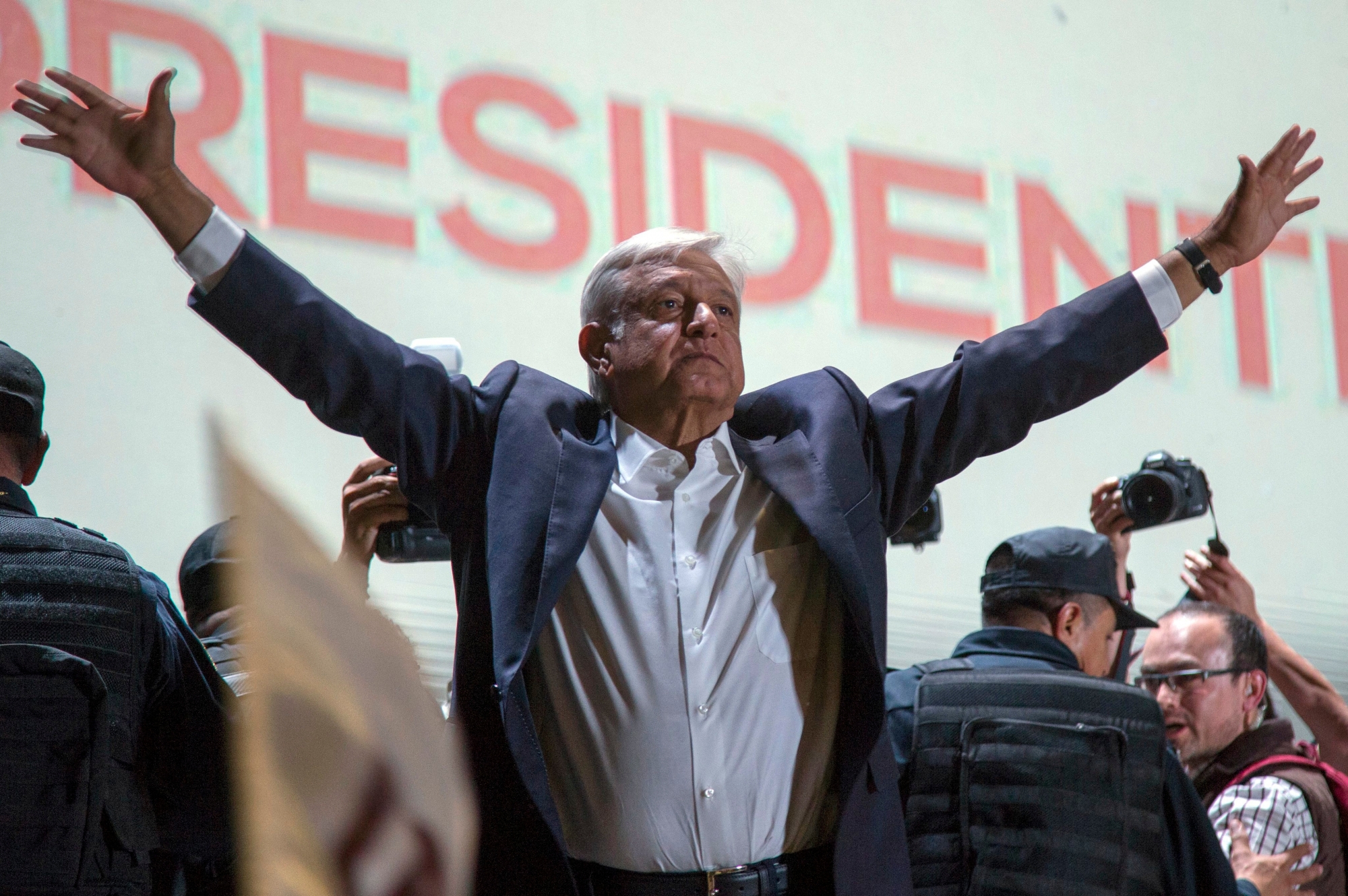 Presidential candidate Andres Manuel Lopez Obrador acknowledges his supporters as he arrives to Mexico City's main square, the Zocalo, Sunday, July 1, 2018. Lopez Obrador has claimed victory in Mexico's presidential election, calling for reconciliation. (AP Photo/Anthony Vazquez) Mexico Elections