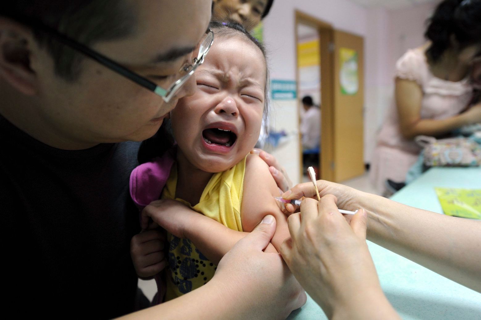 FILE - In this Sept. 11, 2010 file photo, a child cries while receiving a shot of measles vaccine at a health station in Hefei in central China's Anhui province. China's No. 2 leader has ordered an investigation of its vaccine industry after violations by a rabies vaccine producer prompted a public outcry following scandals over shoddy drugs and food. (Chinatopix via AP) China Vaccine Scandal