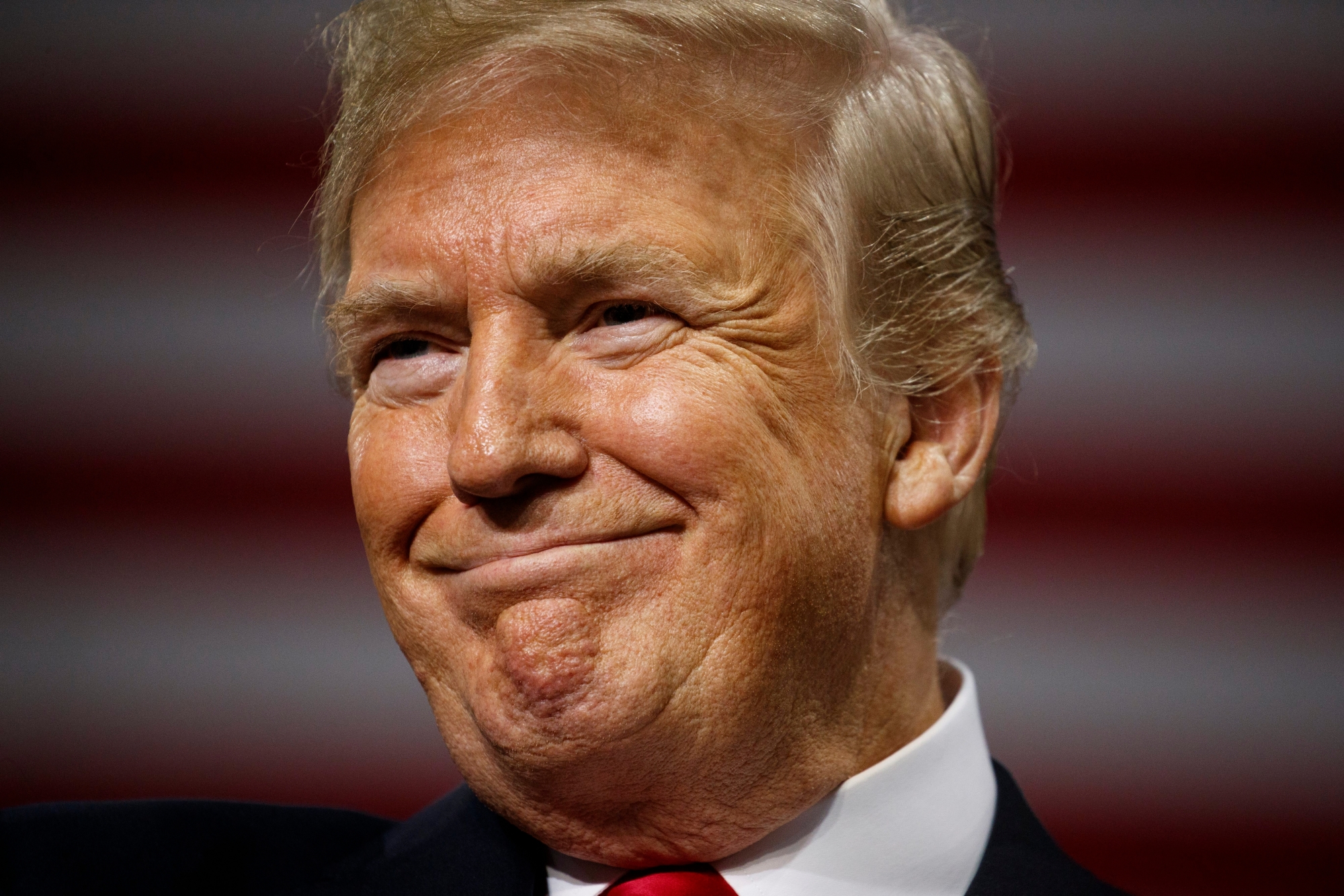 Supporters listen as President Donald Trump smiles during a campaign rally at Florida State Fairgrounds Expo Hall, Tuesday, July 31, 2018, in Tampa, Fla. (AP Photo/Evan Vucci) APTOPIX Trump