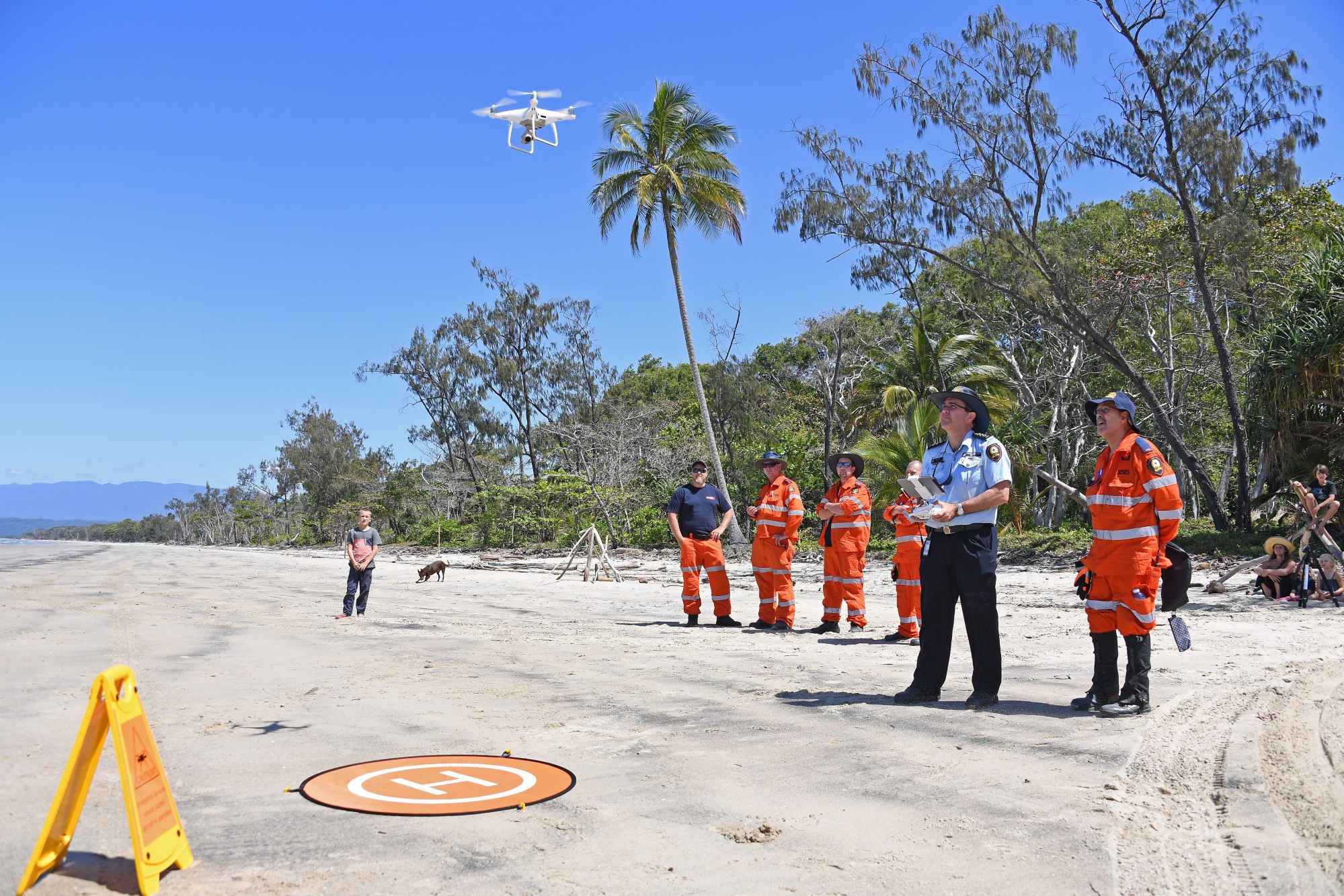 epa06975717 Police and emergency rescue service members launch a search drone at Cape Kimberley at the mouth of the Daintree River in Queensland, Australia, 27 August 2018. Fifteen foreign nationals have been detained and authorities are searching for others who abandoned a boat that ran aground in crocodile country north of Cairns. Locals raised the alarm when they saw a large group of people fleeing the crippled vessel near the mouth of the Daintree River, and make a risky swim to a beach where some vanished into mangroves infested with saltwater crocs.  EPA/BRIAN CASSEY  AUSTRALIA AND NEW ZEALAND OUT AUSTRALIA ILLEGAL BOAT ASYLUM SEEKERS