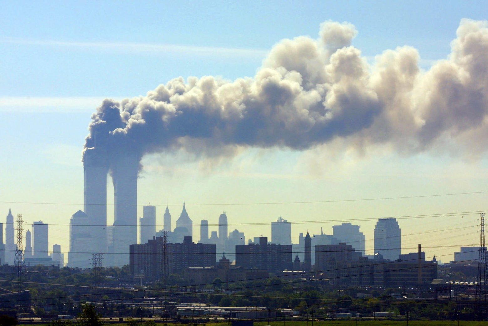 FILE - In this Sept. 11, 2001 file photo, as seen from the New Jersey Turnpike near Kearny, N.J., smoke billows from the twin towers of the World Trade Center in New York after airplanes crashed into both towers.   Families of the victims of the worst terror attack on the United States in history gathered Wednesday, Sept. 11, 2013,  to mark their 12th anniversary with a moment of silence and the reading of names.  The Sept. 11, 2001 attacks in New York City and Washington killed almost 3,000 people and lead to a war in Afghanistan.  (AP Photo/Gene Boyars) Sept 11 Anniversary Photo Gallery