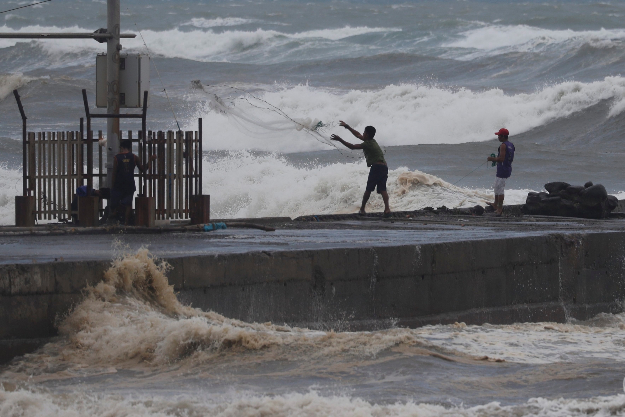 epa07018724 Filipino fishermen fish near the shoreline in the town of Aparri, Cagayan province, Philippines, 14 September 2018. Typhoon Mangkhut, ranked as the most powerful of the year to enter the Philippines braces for the arrival of the storm that is expected to hit the northern island of Luzon. The category 5 typhoon, Mangkhut, named Ompong in the Philippines, is moving with sustained winds of 205 km per hour (127 mph) and gusts of 255 km per hour off the eastern coast of Luzon, according to the Philippine meteorological service Philippine Atmospheric, Geophysical and Astronomical Services Administration (PAGASA).  EPA/FRANCIS R. MALASIG PHILIPPINES WEATHER SUPER TYPHOON MANGKHUT