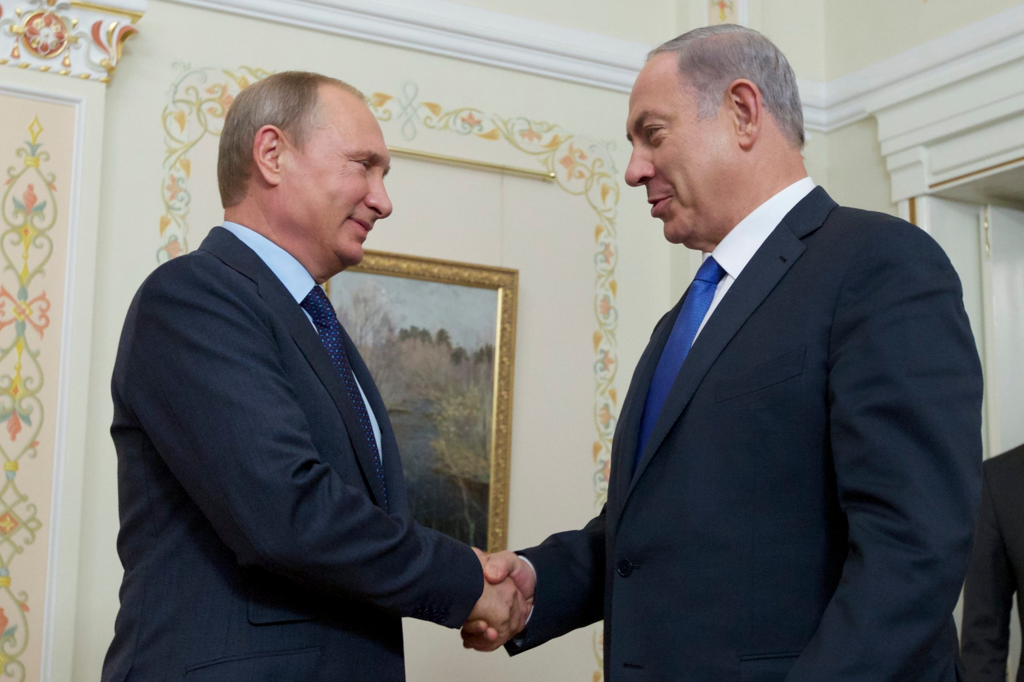 Russian President Vladimir Putin shakes hands with Israeli Prime Minister Benjamin Netanyahu, right, during their meeting in the Novo-Ogaryovo residence, outside Moscow, Russia, Monday, Sept. 21, 2015. (AP Photo/Ivan Sekretarev, Pool) RUSSIA ISRAEL