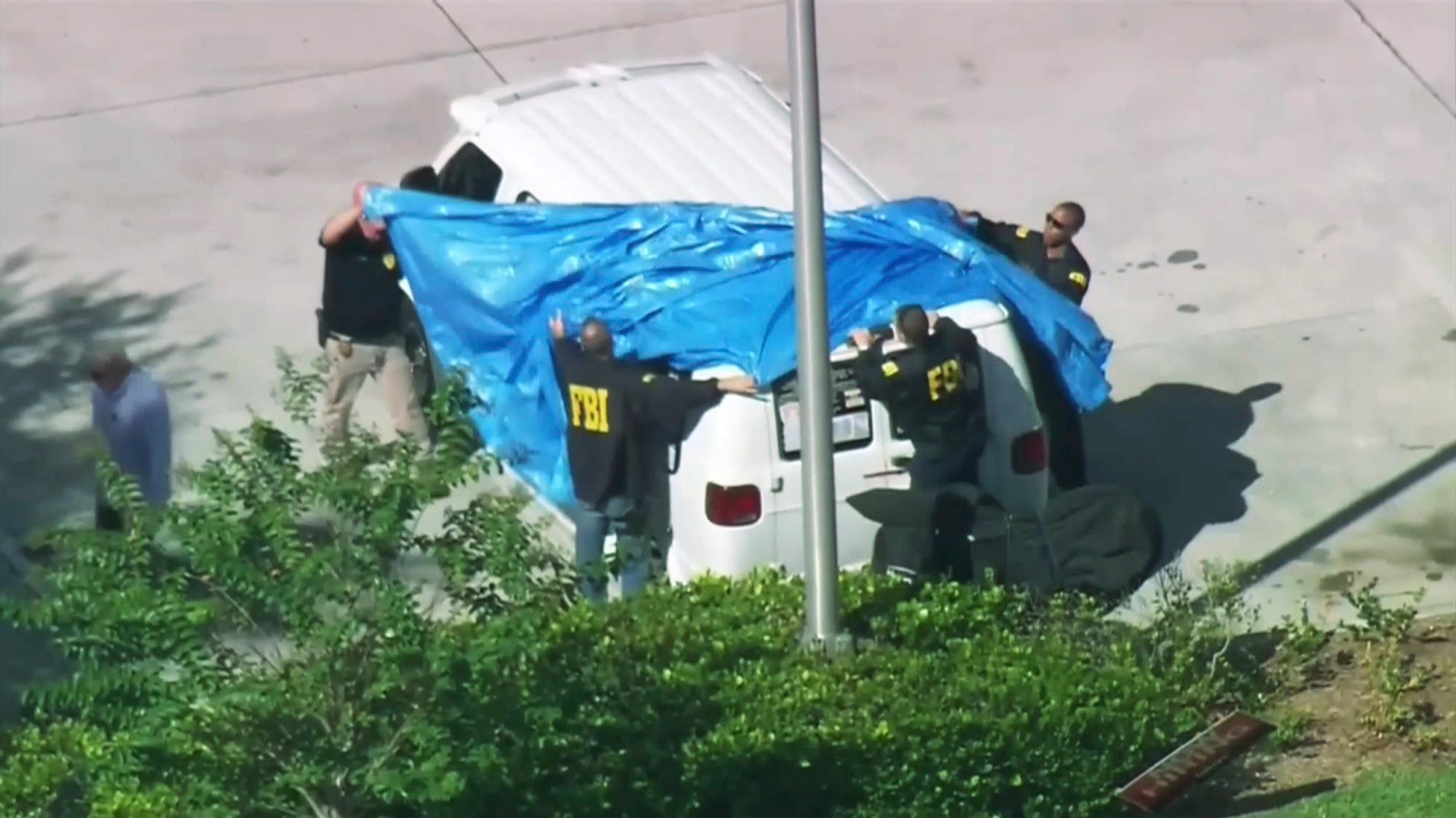 In this frame grab from video provided by WPLG-TV, FBI agents cover a van parked in Plantation, Fla., on Friday, Oct. 26, 2018, that federal agents and police officers have been examining in connection with package bombs that were sent to high-profile critics of President Donald Trump. The van has several stickers on the windows, including American flags, decals with logos and text. (WPLG-TV via AP) Explosive Devices