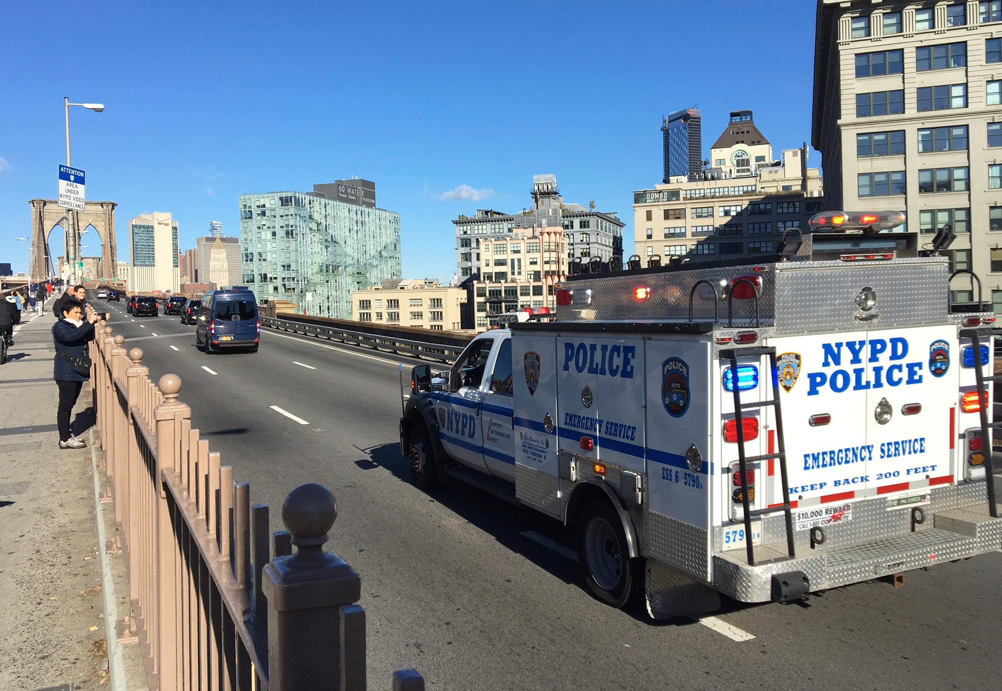 In this Oct. 30, 2018 photo, an NYPD emergency service vehicle brings up the rear of a heavily armed federal law enforcement caravan carrying notorious Mexican drug lord Joaquin "El Chapo" Guzman back to a lower Manhattan jail following a pretrial hearing for his drug conspiracy case at a Brooklyn courthouse. Authorities have been closing the Brooklyn Bridge to traffic when it transports Guzman to and from court, causing logistical issues that have led them to consider alternatives for how to jail him during an upcoming trial that could last three months or longer. (AP Photo/Tom Hays) El Chapo Prosecution
