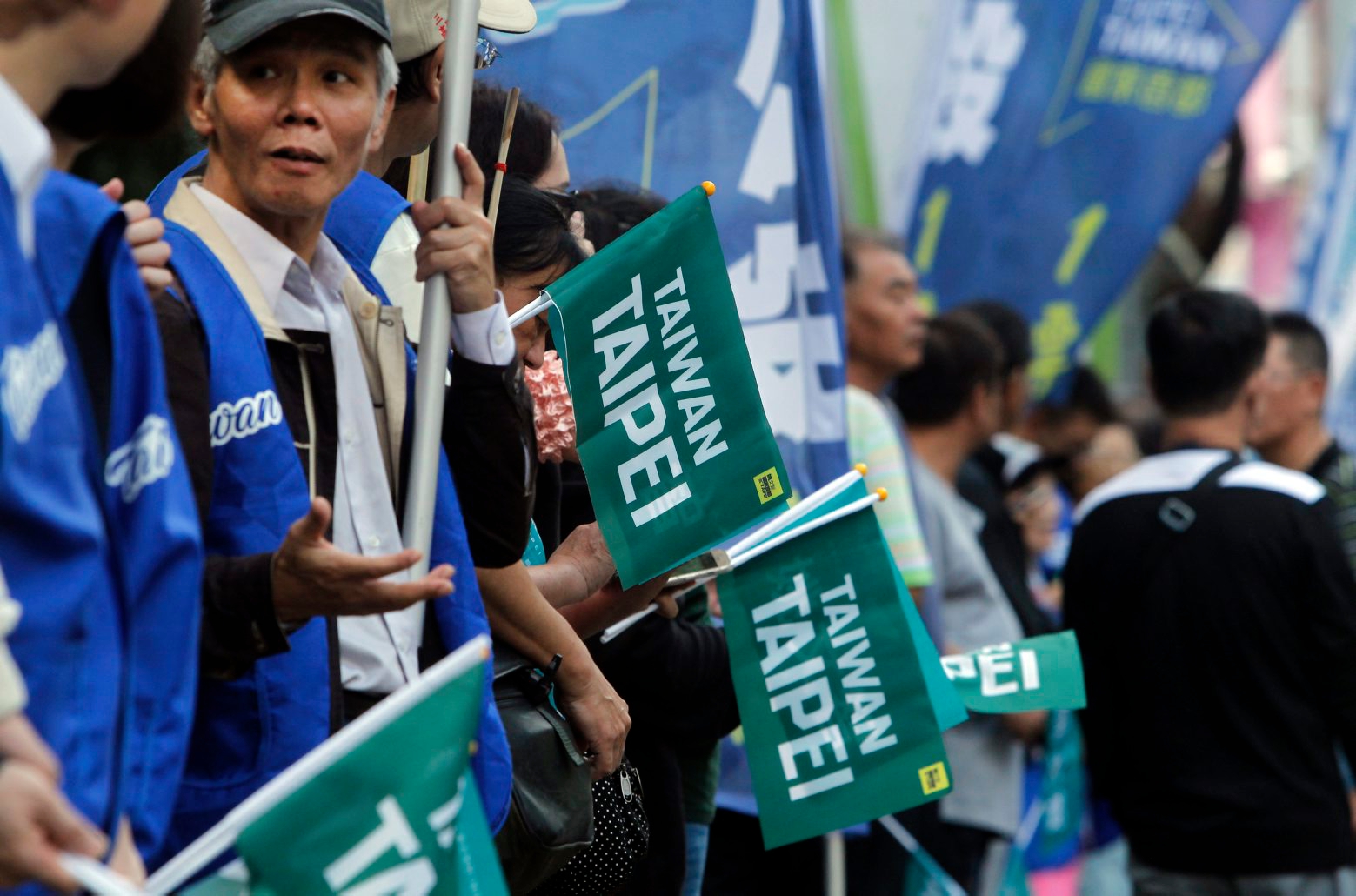 In this Nov. 3, 2018, photo, supporters hold "Taiwan Taipei" flags during a rally for a referendum asking if national teams, including ones for the Olympics, should go by the name "Taiwan Taipei" instead of "Chinese Taipei" in Taipei, Taiwan. Taiwan will vote on a referendum this month asking if the self-ruled island should compete as ÄúTaiwanÄù instead of the present ÄúChinese Taipei.Äù This would include the 2020 Olympics in Tokyo. The controversial referendum has angered China, which sees Taiwan as a breakaway province. (AP Photo/Chiang Ying-ying) Taiwan What's In A Name
