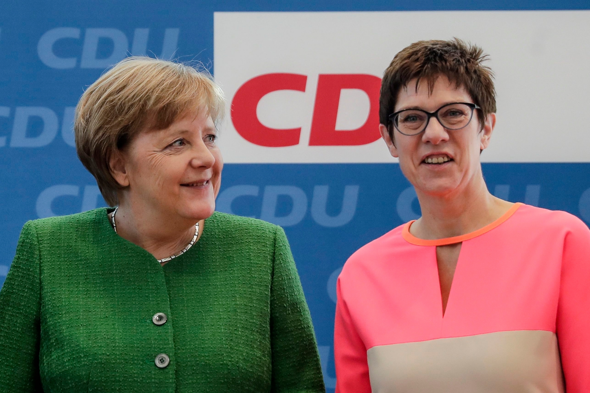 FILE - In this Monday, Feb. 19, 2018 file photo German Chancellor Angela Merkel, left, and the governor of German Saarland state and designated Christian Democratic Union party General Secretary, Annegret Kramp-Karrenbauer, right, attend a party leaders' meeting in Berlin, Germany. The CDU's general secretary since February, Kramp-Karrenbauer _ often called 'AKK' _ is a Merkel ally and the closest to her centrist stance. She touts her own lengthy experience in regional government, which saw her become the first woman to become a state's interior minister, or top security official, and serve as governor of western Saarland state. (AP Photo/Markus Schreiber, file) Germany Merkel's Party