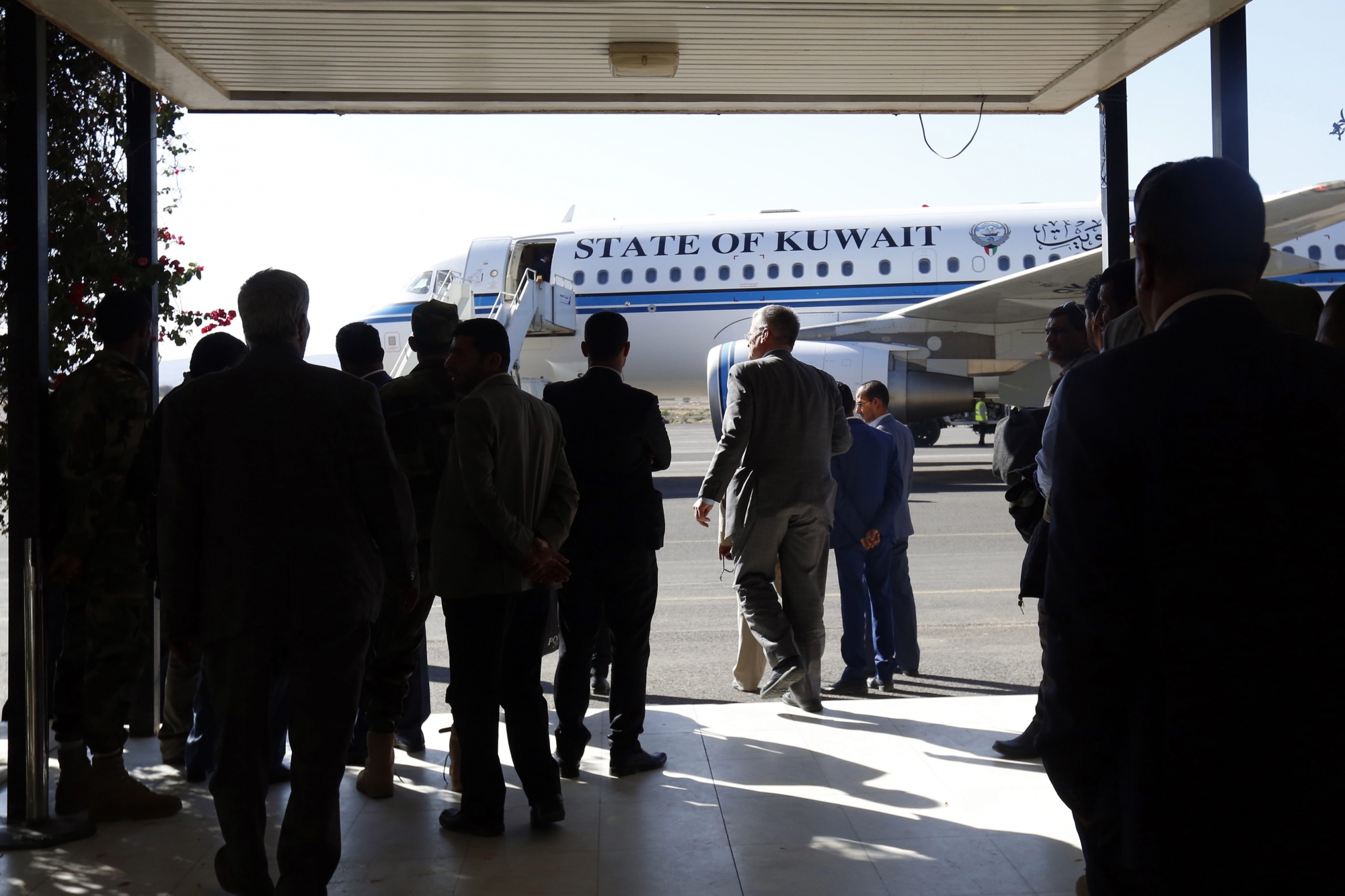 epa07208379 Members of a Houthi delegation wait for a Kuwait-chartered plane as they are accompanied by UN special envoy for Yemen Martin Griffiths and Kuwaiti ambassador to Yemen Fahd Almeie to UN-sponsored peace talks in Sweden, in SanaÄôa, Yemen, 04 December 2018. According to reports, Kuwaiti ambassador to Yemen Fahd Almeie and UN special envoy for Yemen Martin Griffiths accompanied a Houthi negotiating team to Sweden for UN-sponsored peace talks on the ongoing conflict between the Houthi rebels and the Saudi-backed Yemeni government since 2015.  EPA/YAHYA ARHAB YEMEN CONFLICT HOUTHIS PEACE TALKS