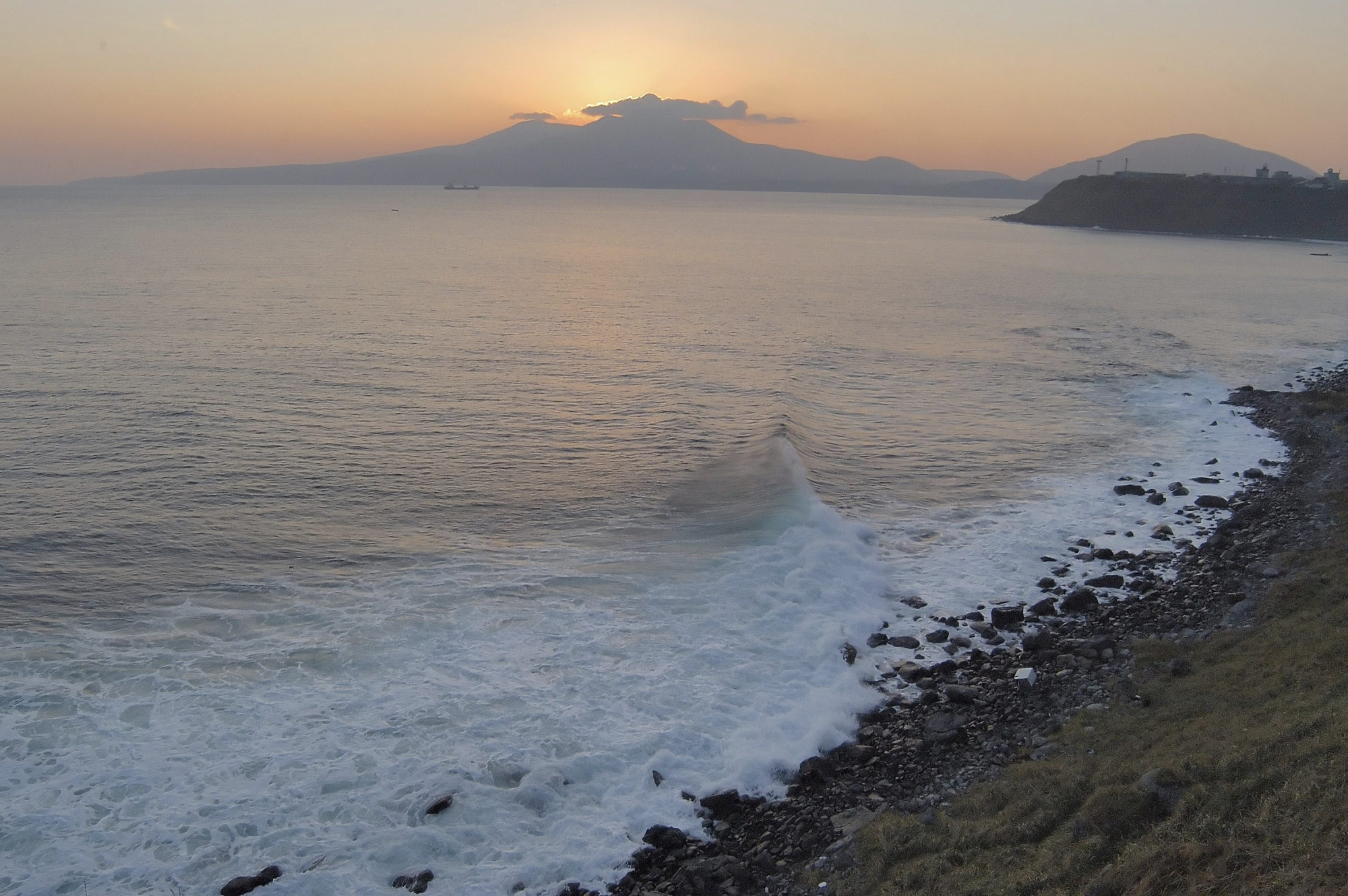 Volcano Mendeleyev is silhouetted against the sunset on Kunashir Island, one of the Kuril Islands, in this recent undated photograph. Russian President Vladimir Putin and Japanese Prime Minister Junichiro Koizumi agreed to try resolving a 60-year territorial dispute over four tiny, sparsely populated islands that has marred bilateral ties, and said better economic ties will help. The dispute over the Kuril islands, which were seized by Soviet troops toward the end of the war, has prevented Russia and Japan from signing a World War II peace treaty. (KEYSTONE/AP Photo)                               RUSSIA JAPAN