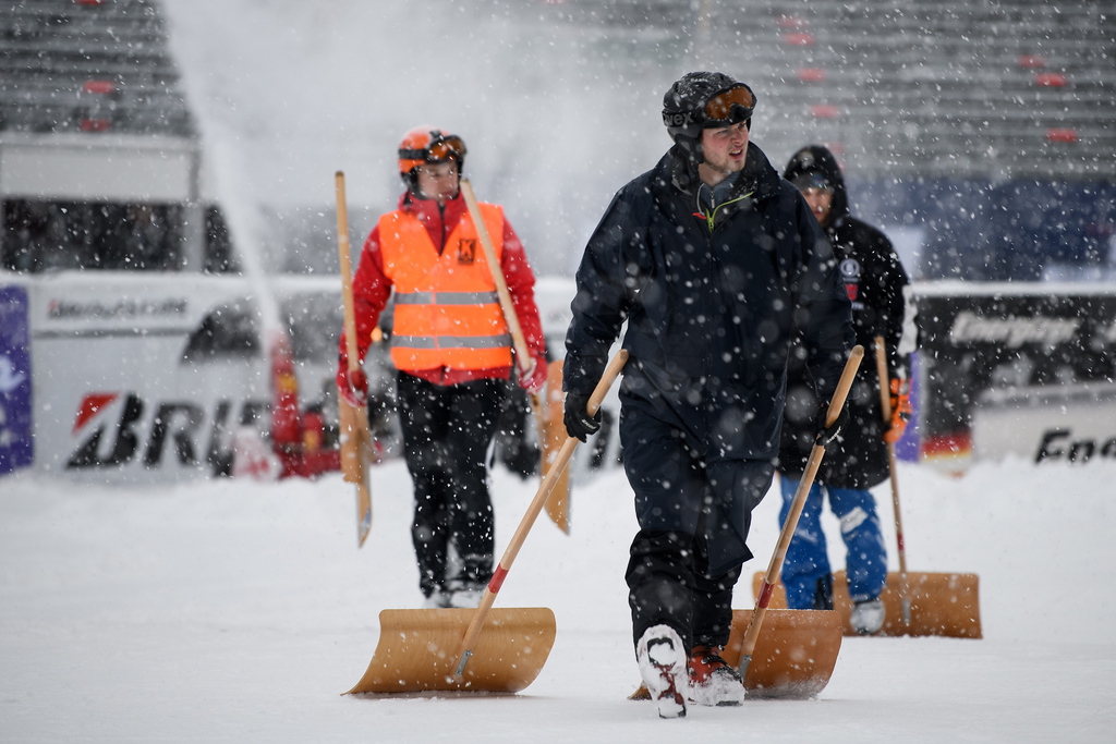 epa07320516 Volunteers work to clear the finish area before the women's Super-G of the FIS Alpine Ski World Cup season in Garmisch-Partenkirchen, Germany, 26 January 2019.  EPA/PHILIPP GUELLAND