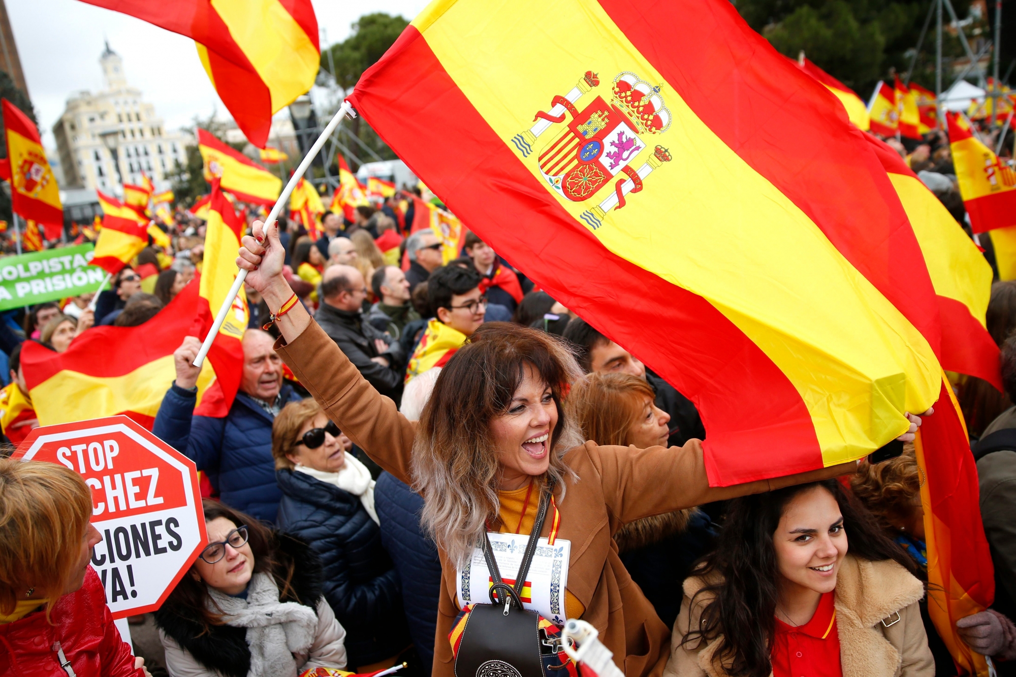 Demonstrators wave Spanish flags during a protest in Madrid, Spain, on Sunday, Feb.10, 2019. Thousands of Spaniards in Madrid are joining a rally called by right-wing political parties to demand that Socialist Prime Minister Pedro Sanchez step down. Banner reads in Spanish "coup leaders must go to the prison". (AP Photo/Andrea Comas) Spain Politics