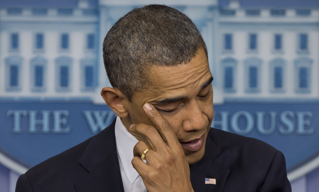 President Barack Obama wipes his eye as he talks about the Connecticut elementary school shooting, Friday, Dec. 14, 2012, in the White House briefing room in Washington. (AP Photo/Carolyn Kaster)