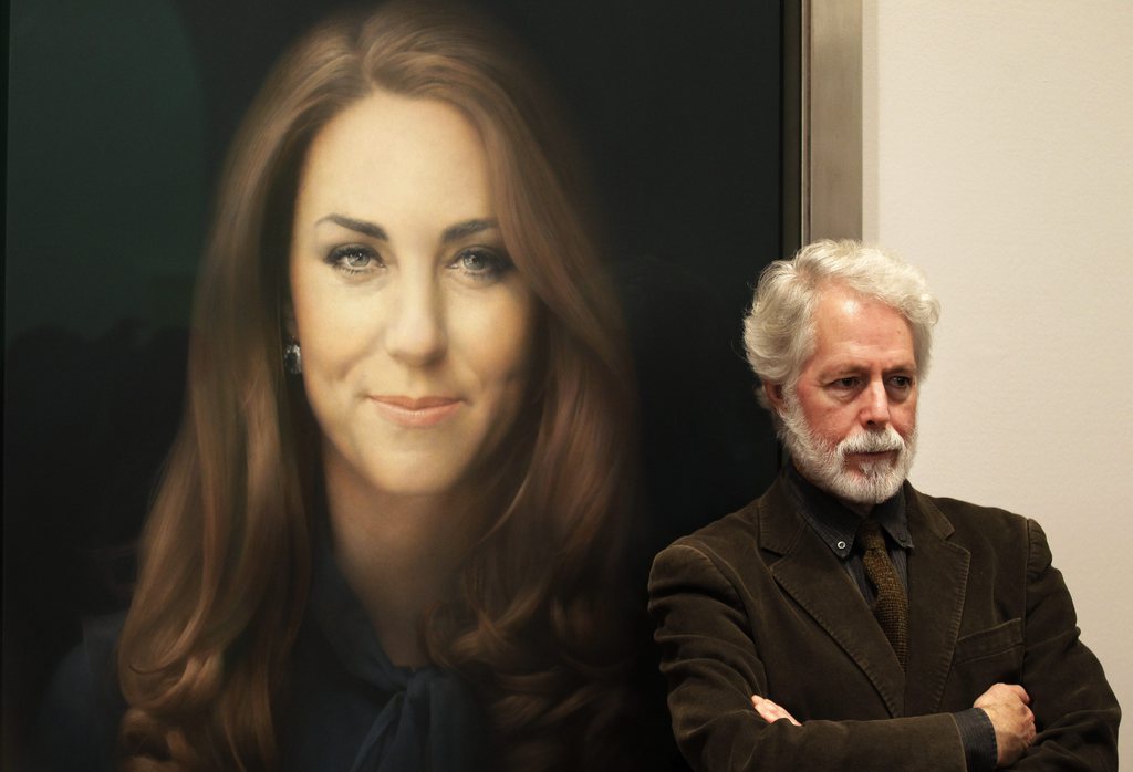 Artist Paul Emsley poses for photographers next to his newly-commissioned portrait of Kate, Duchess of Cambridge, on display at the National Portrait Gallery in London, Friday, Jan. 11, 2013. (AP Photo/Sang Tan)