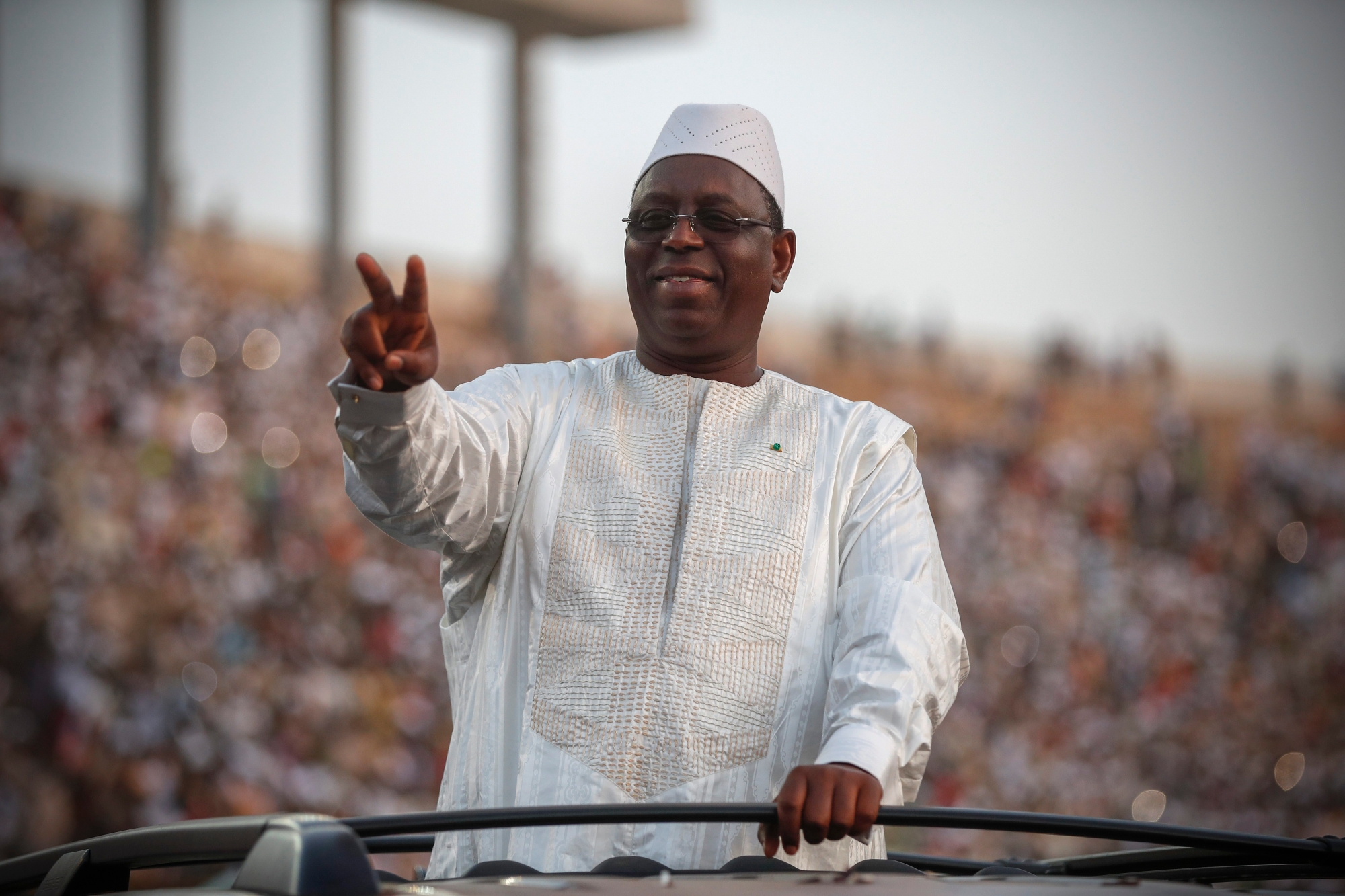 epa07388683 Senegal, incumbent President Macky Sall greets a cheering crowd as he arrives for the last campaign rally in Dakar, Senegal, 22 February 2019. Presidential elections will be held in Senegal on 24 February 2019. The vote will be the 11th straight presidential election since Senegal gained independence from France in 1960. Incumbent President Macky Sall is amongst five candidates for the presidency.  EPA/NIC BOTHMA SENEGAL PRESIDENTIAL ELECTIONS