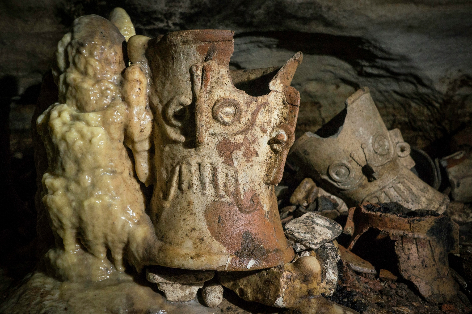 Pre-columbian artifacts sit in a cave at the Mayan ruins of Chichen Itza, Yucatan, Mexico, Tuesday, Feb. 19, 2019. Mexican archaeologists say they have found a cave at the Mayan ruins of Chichen Itza with offerings of about 200 ceramic vessels in nearly untouched condition. The National Institute of Anthropology and History says the vessels appear to date back to around 1,000 A.D. (Karla Ortega/Mexico's National Institute of Anthropology and History via AP) Mexico Archaeology