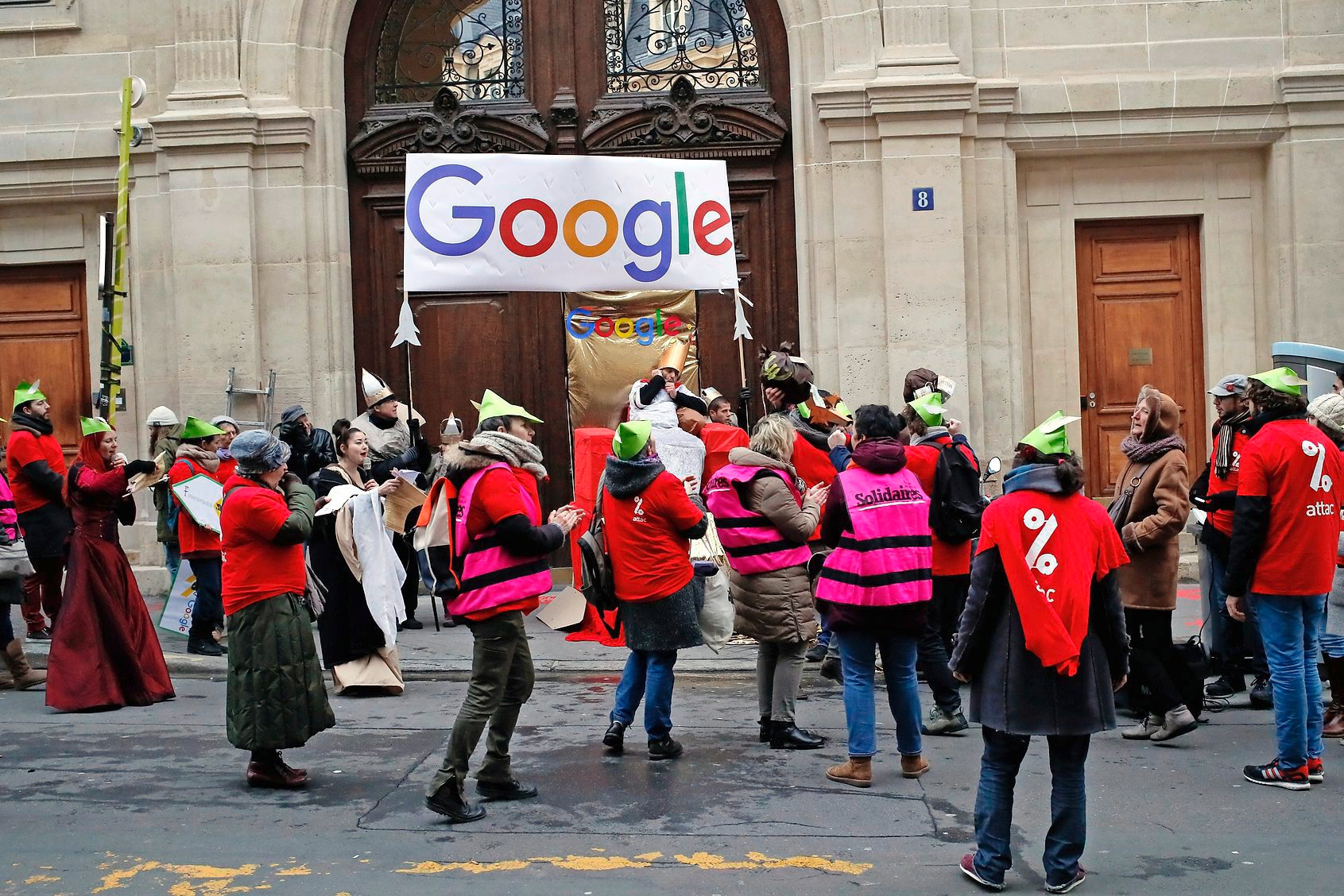 Activists from anti-globalization organisation Attac stage a protest at Google's Paris headquarters to criticize the company's tax evasion policies, in Paris, Thursday, Jan. 31, 2019. According to Attac, Google's French subsidiary reported revenue of 325 million euros (371 million dlrs) in 2017 and paid 14 million euros (16 million dlrs) in income tax. The group says Google France shifts more than 85 percent of its French revenue to countries with more favorable tax regimes. France's finance minister Bruno Le Maire earlier this month announced plans to tax multinational technology companies such as Google with a turnover of more than 750 million euros worldwide and 25 million euros in France. (AP Photo/Francois Mori) FRANCE GOOGLE PROTEST