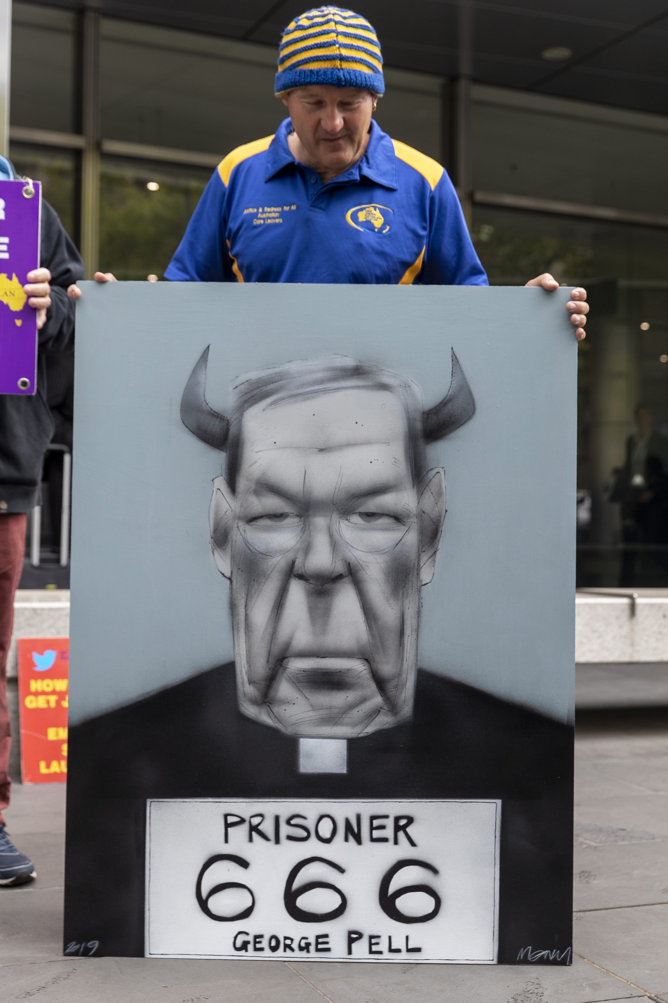 epa07432559 Protesters of Cardinal George Pell are seen outside the County Court in Melbourne, Australia, 13 March 2019. Cardinal Pell, once the third most powerful man in the Vatican and Australia's most senior Catholic, is being sentenced after being found guilty of child sexual abuse.  EPA/DANIEL POCKETT AUSTRALIA AND NEW ZEALAND OUT AUSTRALIA GEORGE PELL COURT