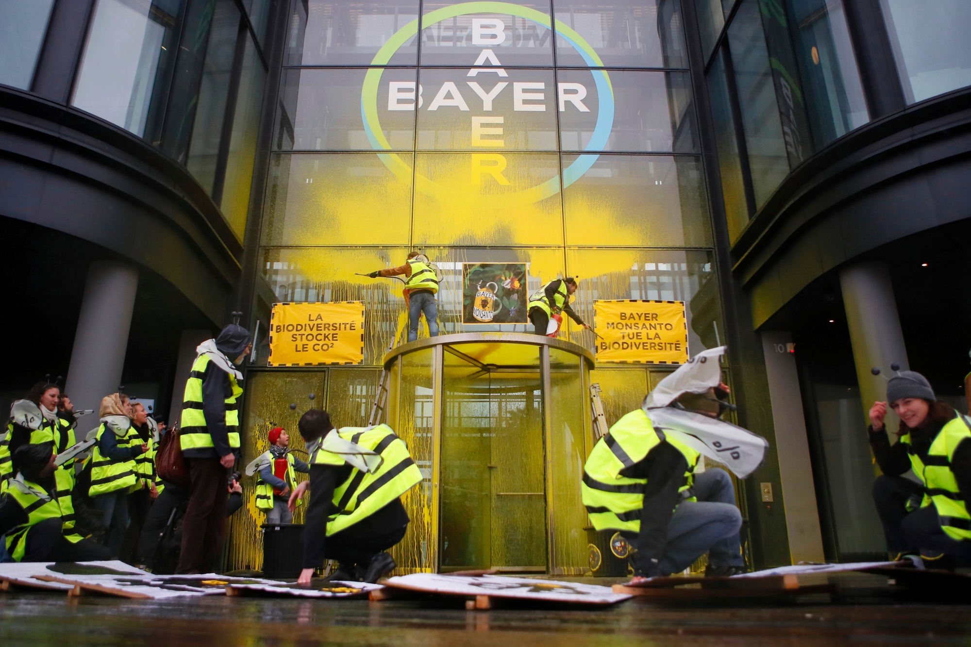 French activists of Attac stage a demonstration in front of the Paris headquarters of Bayer AG to protest its production of environment-damaging pesticides in la Garenne Colombes, suburb of Paris, Thursday, March 14, 2019. Germany-based Bayer is also under fire from environmental activists in Europe and the U.S. for production of weed killer Roundup by its subsidiary Monsanto. Roundup's key ingredient glyphosate has been blamed for health problems including cancer. (AP Photo/Francois Mori) France Protest