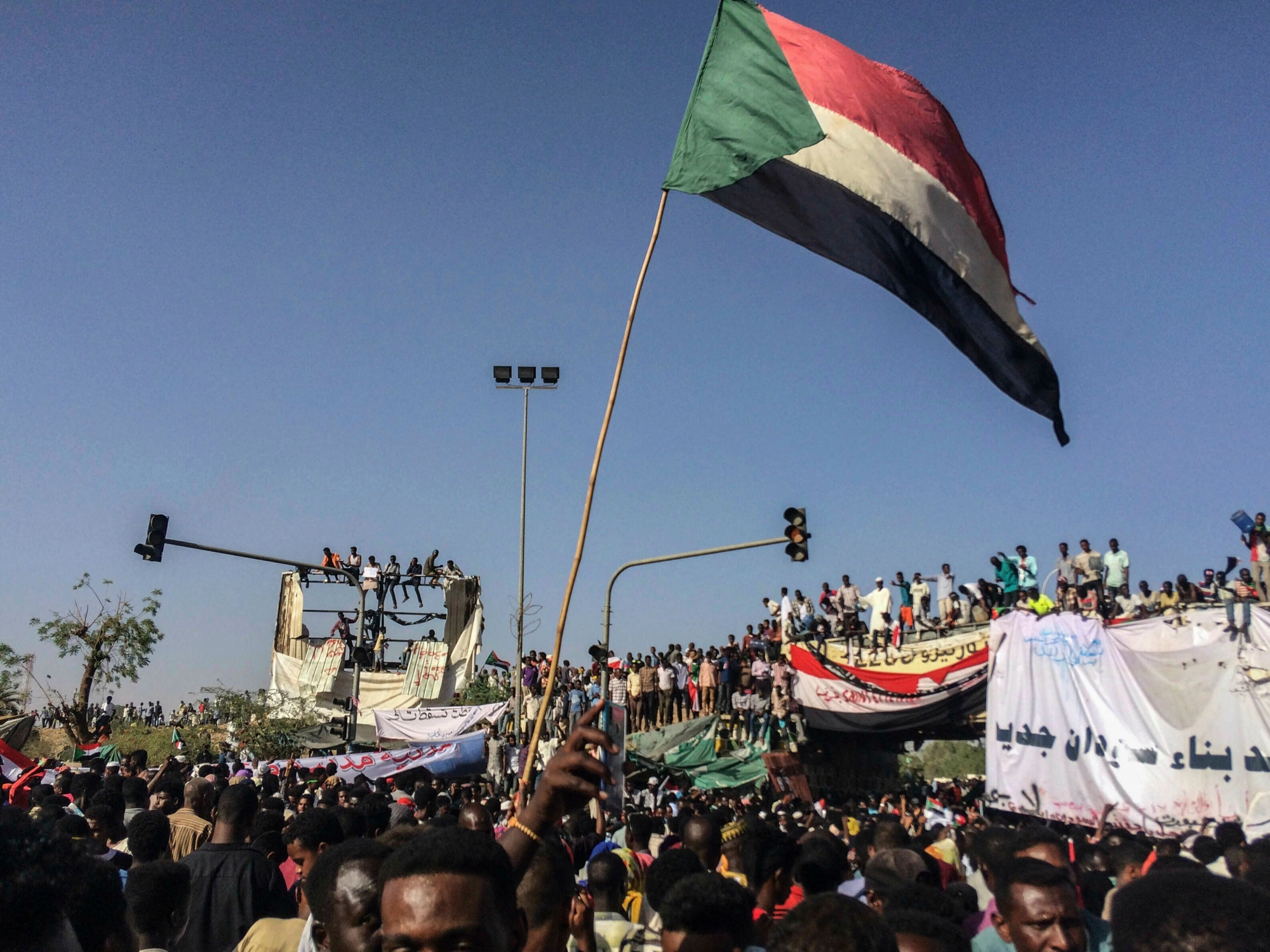 Sudanese demonstrators march with national flags as they gather during a rally demanding a civilian body to lead the transition to democracy, outside the army headquarters in the Sudanese capital Khartoum on Saturday, April 13, 2019.   The military overthrew President Omar al-Bashir on Thursday after almost four months of protests calling for an end to his nearly 30-year rule.  (AP Photo) Sudan