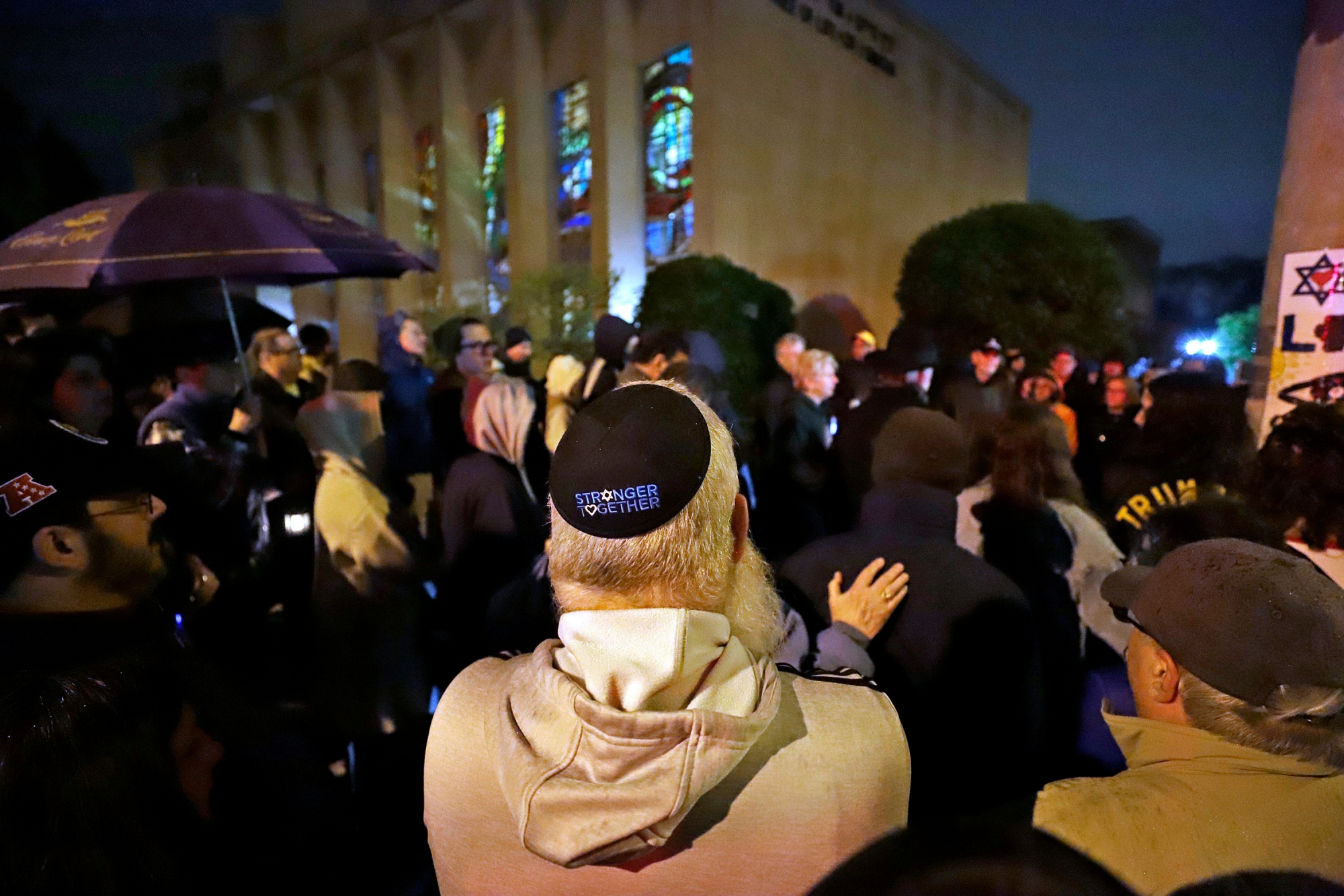 A group gathers outside the Tree of Life Synagogue for a vigil to honor the victims of the Saturday attack on a synagogue in California, Saturday April 27, 2019, in the Squirrel Hill neighborhood of Pittsburgh. It is six months to the day that a gunman shot and killed 11 people while they worshipped at the Tree of Life Synagogue on Oct. 27, 2018. (AP Photo/Gene J. Puskar) Synagogue Shooting California Pittsburgh