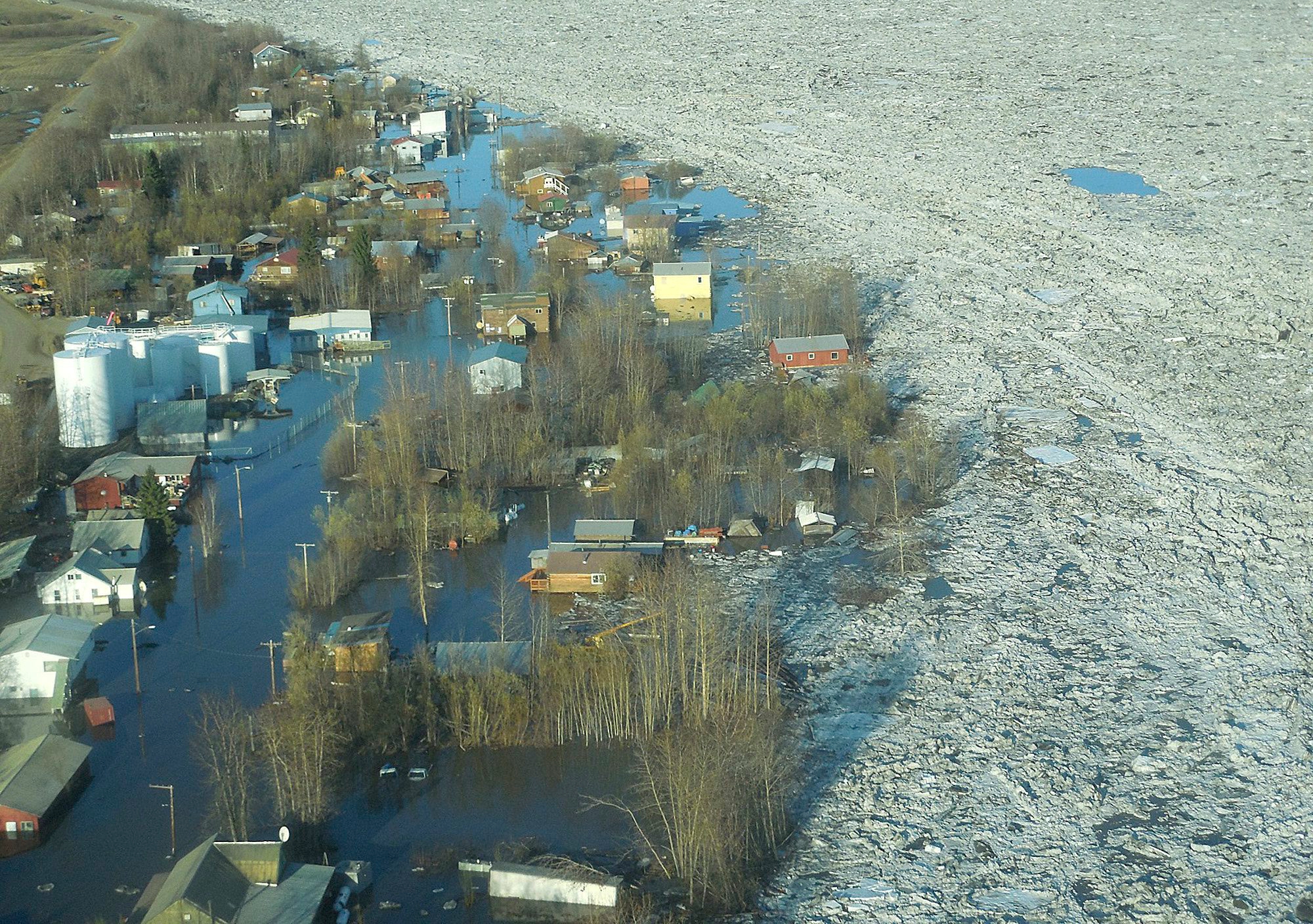 In this May 27, 2013 photo released by the National Weather Service, ice and water are shown flooding homes and other buildings in Galena, Alaska. Several hundred people are estimated to have fled the community of Galena in Alaska's interior, where a river ice jam has caused major flooding, sending water washing over roads and submerging buildings. (AP Photo/National Weather Service, Ed Plumb) Alaska Flooding