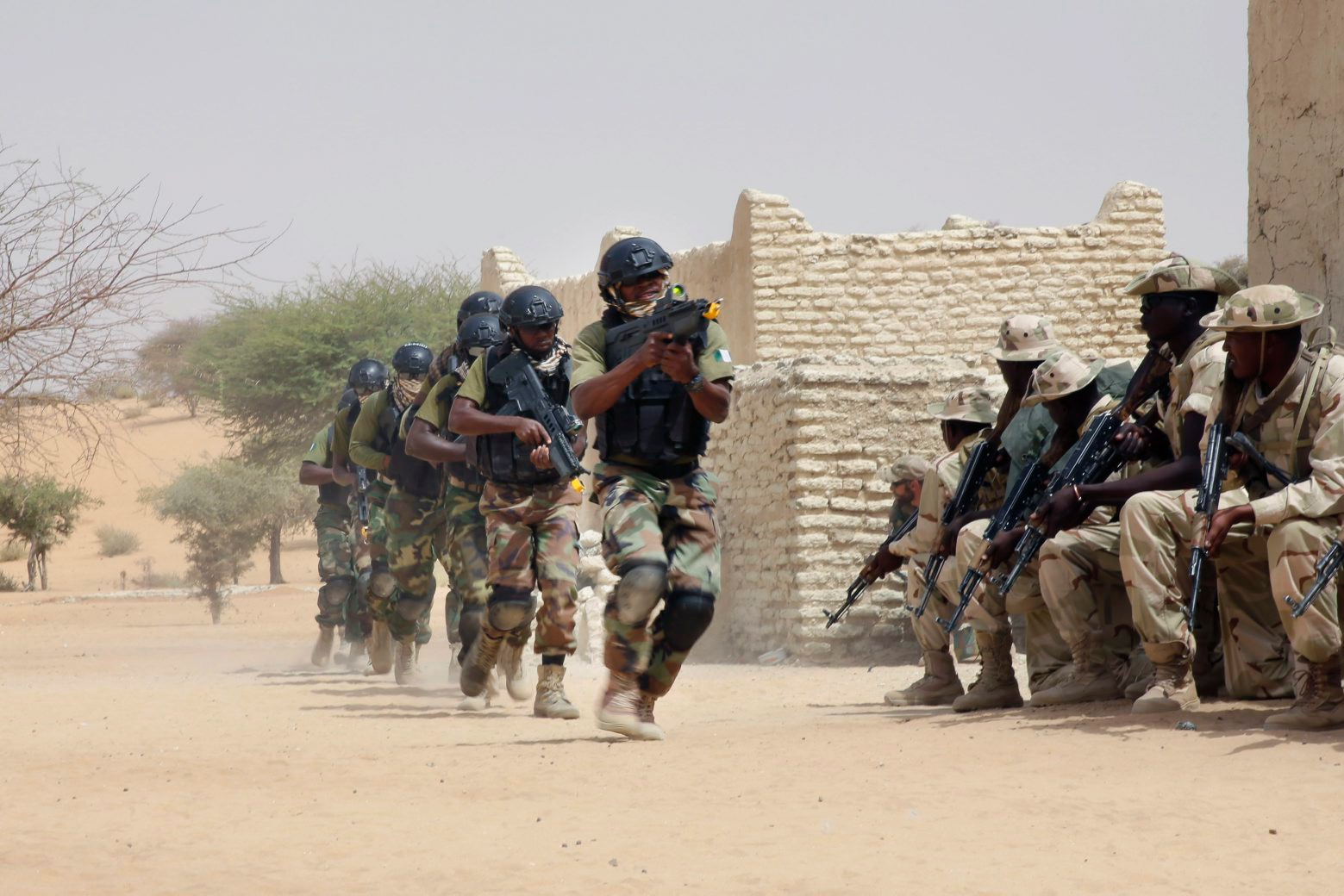 Nigerian special forces run past Chadian troops in an hostage rescue exercise at the end of the Flintlock exercise in Mao, Chad, Saturday, March 7, 2015. The U.S. military and its Western partners conduct this training annually and set up plans long before Boko Haram began attacking its neighbors Niger, Chad and Cameroon. (AP Photo/Jerome Delay) Chad Boko Haram Flintlock