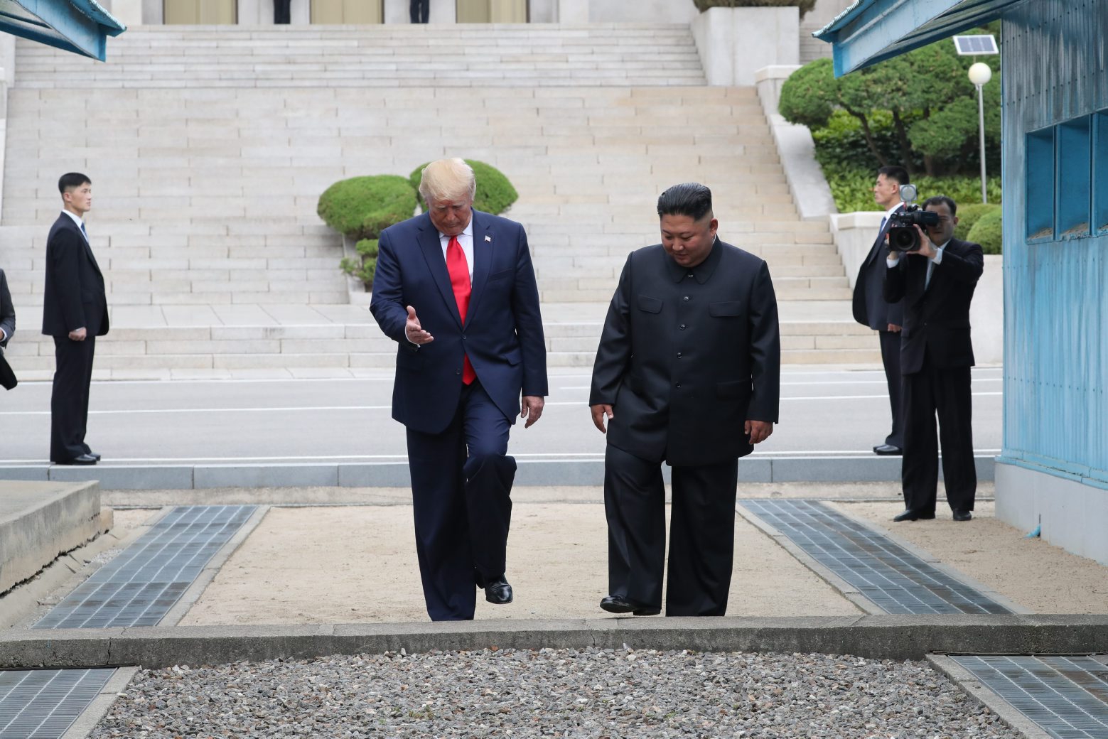 epa07683961 US President Donald J. Trump (L) with North Korean leader Kim Jong-un cross the Military Demarcation Line into the southern side of the truce village of Panmunjom in the Demilitarized Zone, which separates the two Koreas, 30 June 2019. The US leader arrived in South Korean on 29 June for a two-day visit that will include a meeting with South Korean President Moon Jae-in and a trip to the Demilitarized Zone.  EPA/YONHAP SOUTH KOREA OUT SOUTH KOREA NORTH KOREA DIPLOMACY