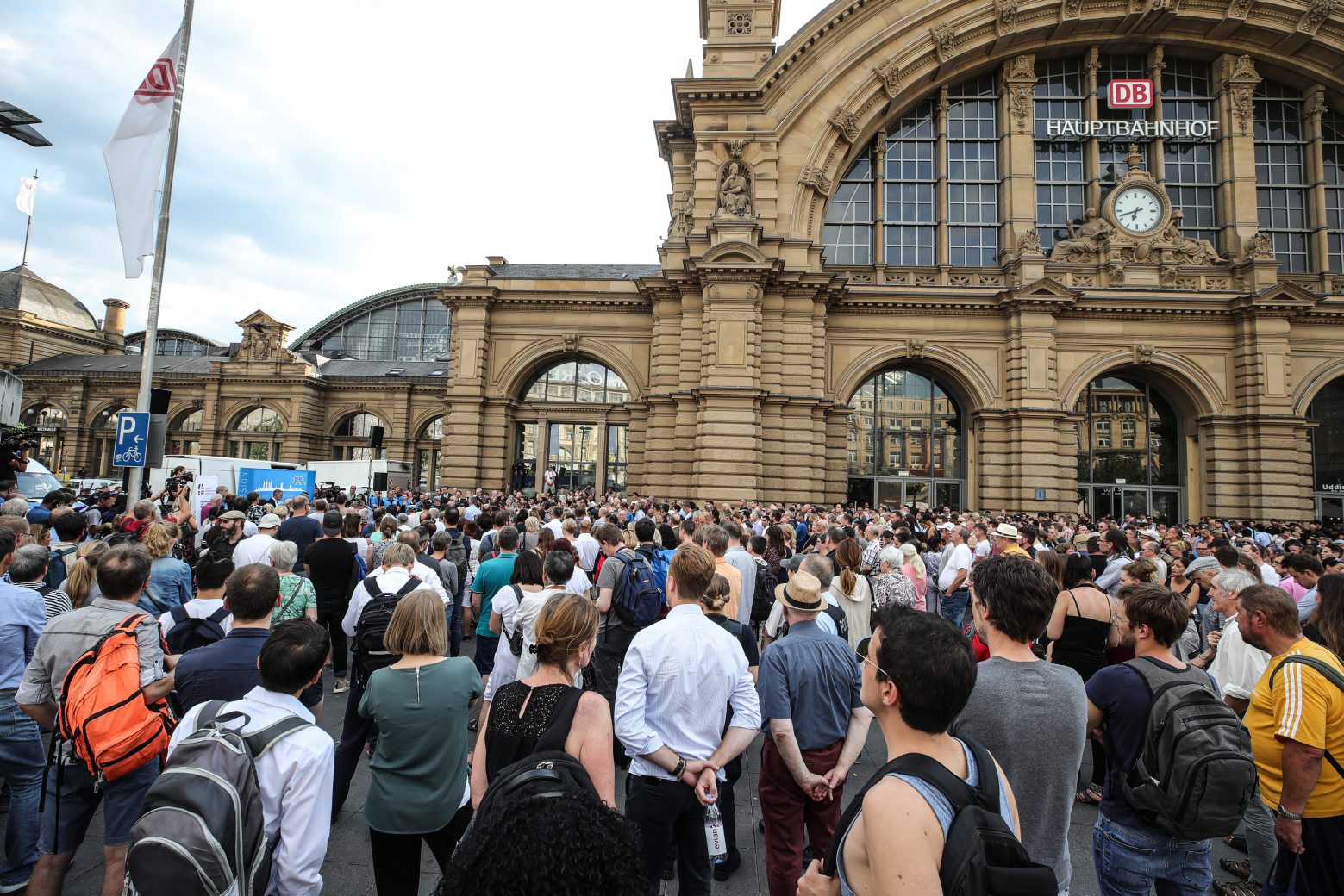 epa07748847 People take part at a memorial service in front of the Central station in Frankfurt am Main, Germany, 30 July 2019,  one day after an eight-year-old boy died after being pushed onto the rail tracks in front of an incoming train. The boy's mother was also pushed onto the tracks, but was able to save herself. One man has been arrested in connection with the attack.  EPA/ARMANDO BABANI GERMANY CRIME