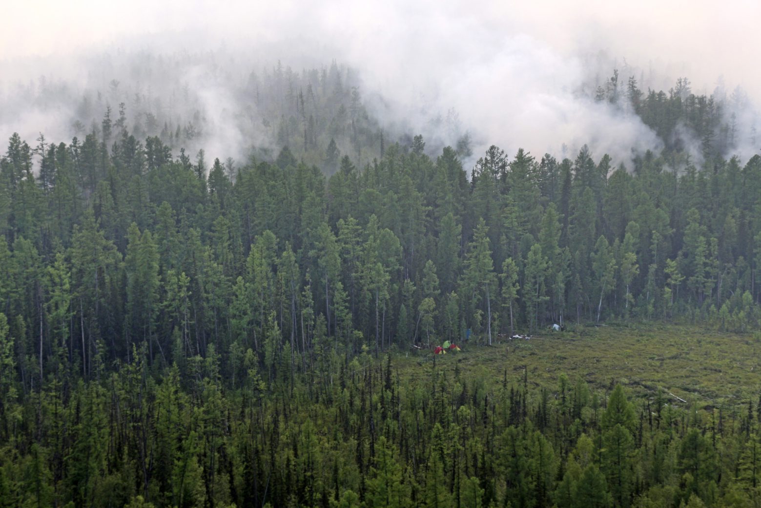 This photo taken on Monday, July 29, 2019 and provided by Russian Federal Agency of Forestry, shows an air view of a forest fire in the Boguchansky district of the Krasnoyarsk region, Russia Far East. Russian President Vladimir Putin has ordered Russia's military to join efforts to fight forest fires that have engulfed nearly 30,000 square kilometers (11,580 sq. miles) of territory in Siberia and the Russian Far East. (Russian Federal Agency of Forestry via AP) Russia Forest Fires
