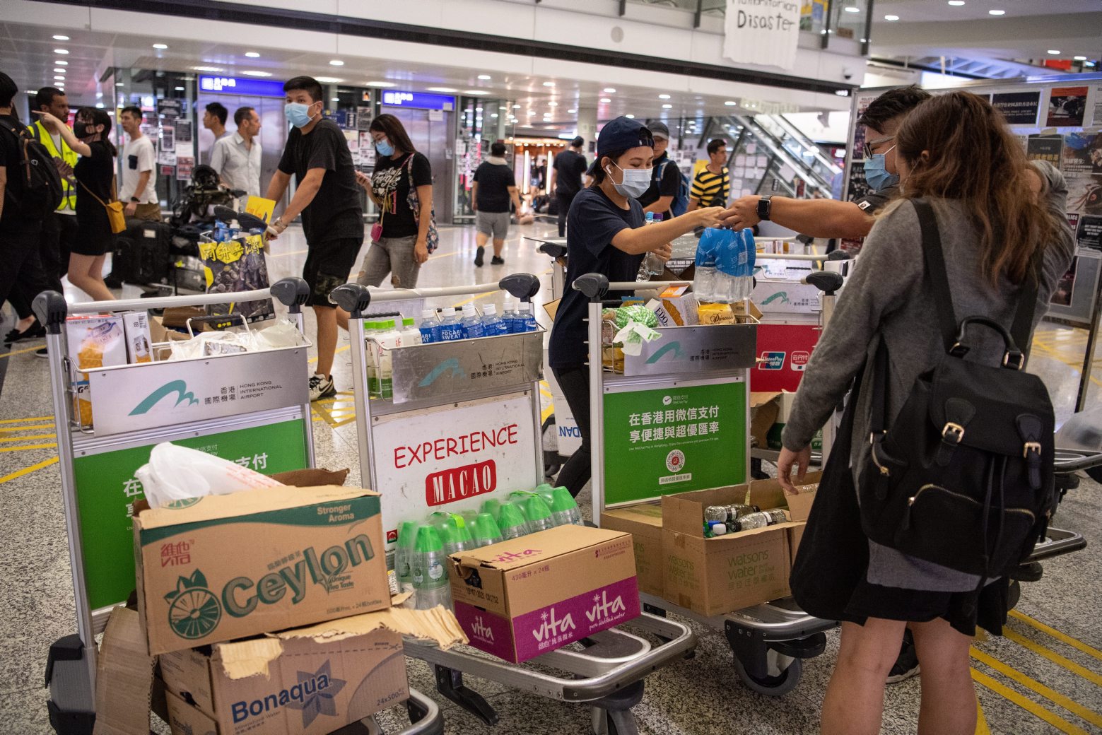 epa07770184 Protesters occupying Hong Kong Chek Lap Kok International Airport offer free food and water in Hong Kong, China, 12 August 2019. According to media reports, the Airport Authority said it is virtually shutting down the airport, one of the busiest in the world, as thousands of protesters occupied both the arrival and departure halls of Chek Lap Kok. Hong Kong has been gripped for weeks by mass protests, which began in June 2019 over a now-suspended extradition bill to China and have developed into an anti-government movement.  EPA/LAUREL CHOR CHINA HONG KONG AIRPORT PROTESTS