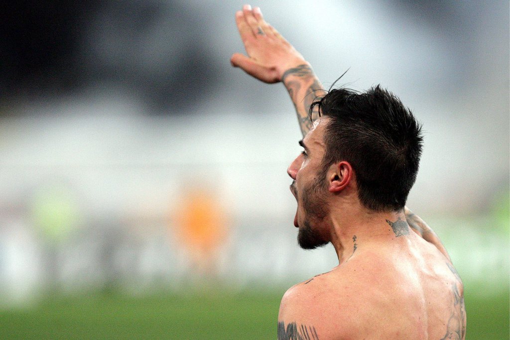 epa03628613 AEK Athens midfielder Giorgos Katidis celebrates by giving the Nazi salute to spectators after scoring the winning goal in his team's 2-1 Super League victory over Veria at the Olympic Stadium in Athens, Greece, 16 March 2013. The 20-year-old Katidis pleaded ignorance of the meaning of his gesture, claiming that he detests fascism. Responding to heavy criticism after the match, Katidis said he was unaware of the implications of his celebration.  EPA/STRINGER