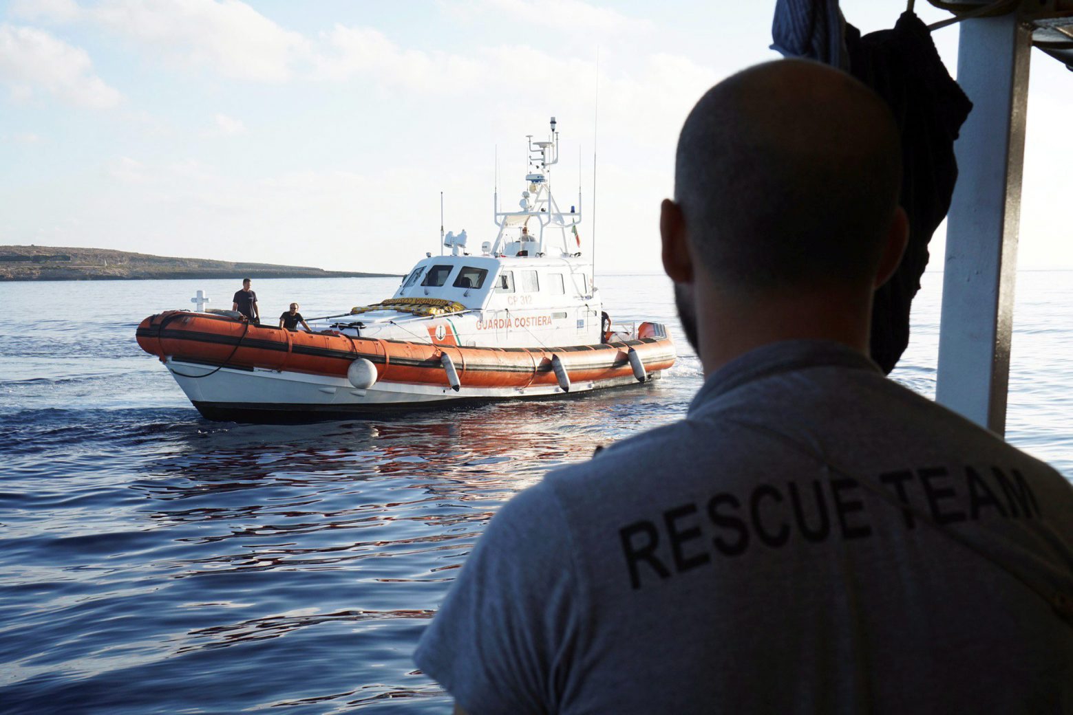 epa07778960 Italian Coast Guard keeps an eye on Spanish rescue vessel Open Arms with 107 migrants, near Lampedusa, Italy, 18 August 2019. A day after 27 minors and ill migrants were evacuated, the rescue vessel is still stranded off coast of Italy as it waits to reach a safe port in the Mediterranean sea, despite the Lazio Regional Administrative Court accepted its appeal, suspending the ban on entry into Italian waters ordered by Italian Interior Minister Matteo Salvini.  EPA/FRANCISCO GENTICO ITALY MIGRATION OPEN ARMS