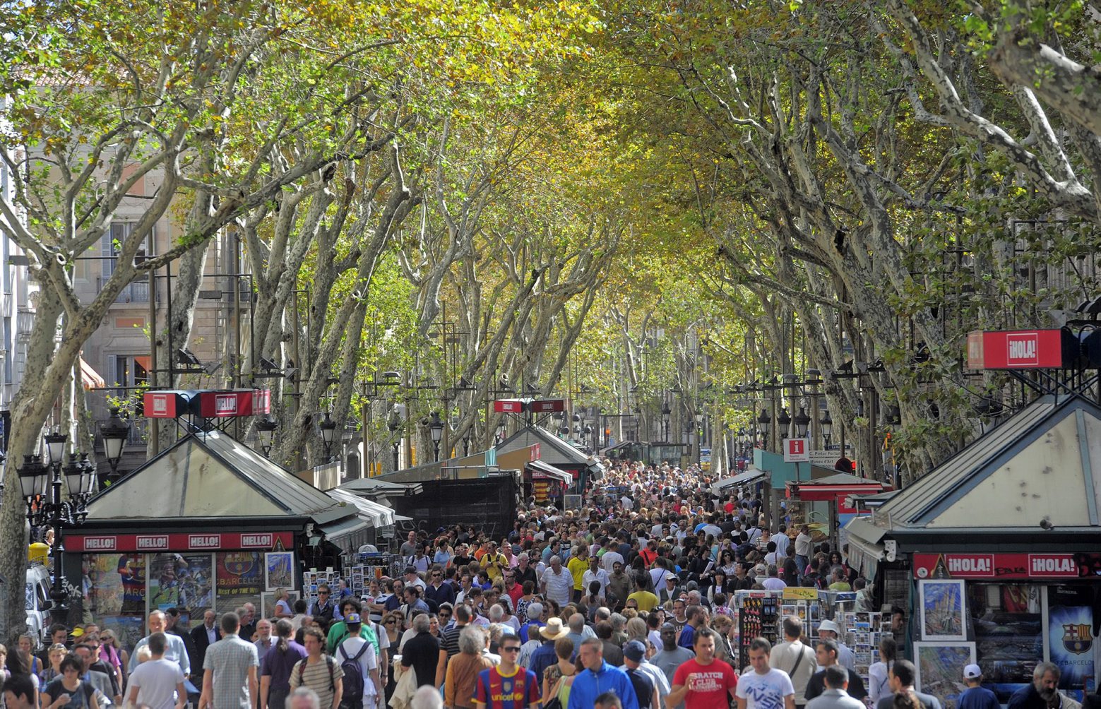 FILE - In this Oct. 4, 2010 file photo, people walk along Ramblas Street in Barcelona, Spain.  Police officials in Spain said on Wednesday Aug. 21, 2019, that muggings or street robberies, employing violence or intimidation have spiked sharply in Barcelona. (AP Photo/Manu Fernandez, File) Spain Barcelona Crime