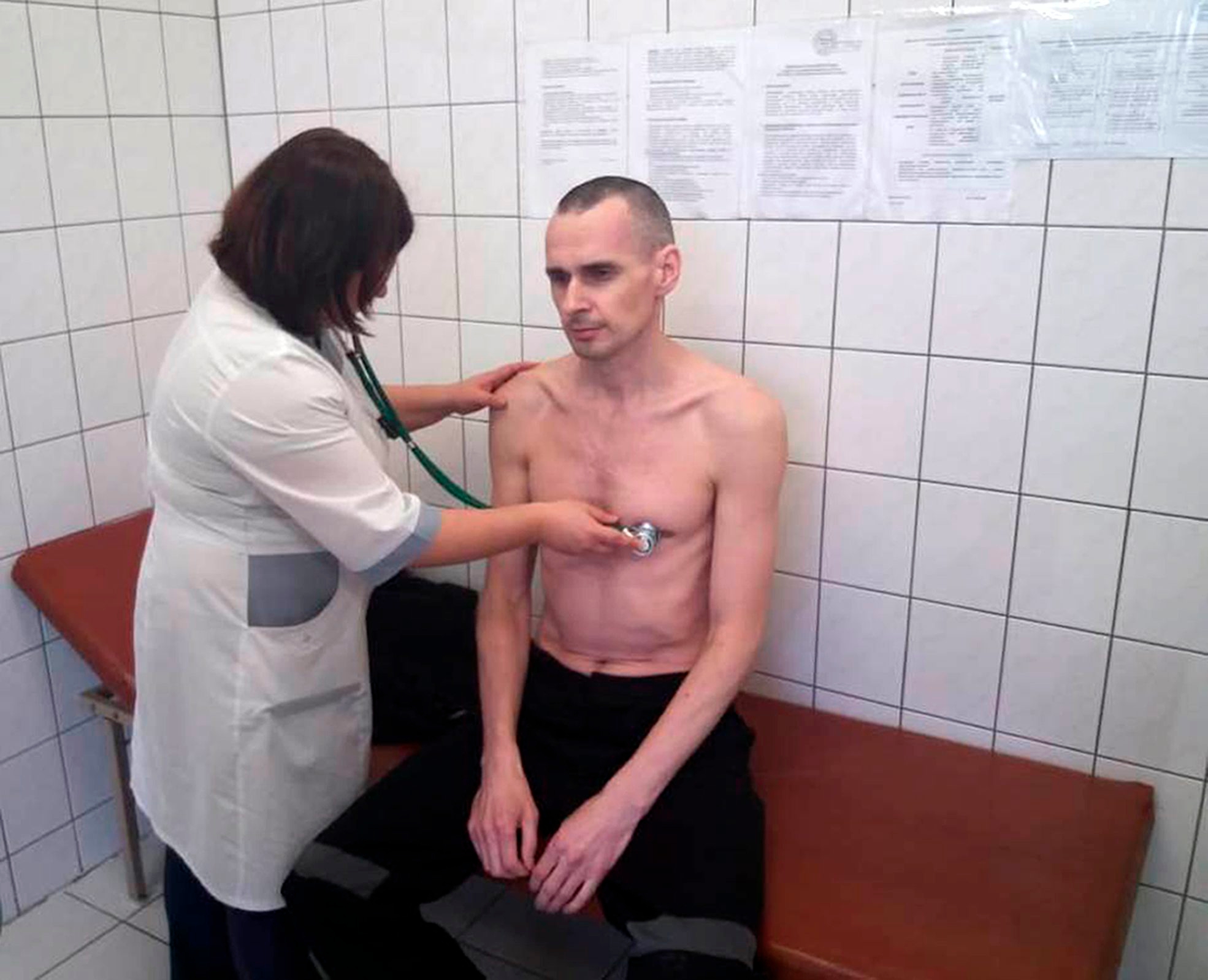 FILE - In this handout file photo taken on Friday, Sept. 28, 2018 and released by Russian Federal Penitentiary Service, a doctor examines imprisoned Ukrainian filmmaker Oleg Sentsov in the hospital in Labytnangi, Yamalo-Nenets region, Russia. The EU has awarded the Sakharov Prize for human rights to jailed Ukrainian filmmaker Oleg Sentsov, it was announced on Thursday, Oct. 25 2018. ( (Russian Federal Penitentiary Service via AP, File) EU Sakharov Prize
