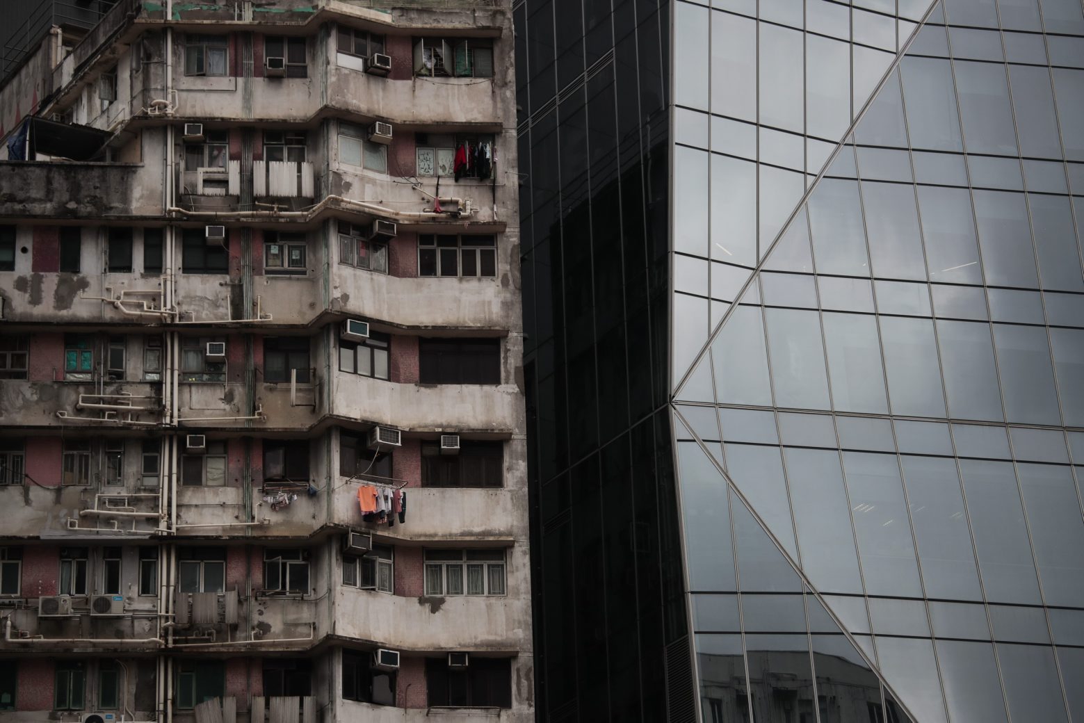 In this Sept. 1, 2019, photo, an old apartment building stands next to a gleaming tower in Hong Kong. Life is not quite normal after three months of steady protests in the Asian financial center - and yet normal life goes on, as it must, for the cityÄôs 7.4 million residents. (AP Photo/Jae C. Hong) APTOPIX Hong Kong Life Goes On Photo Gallery