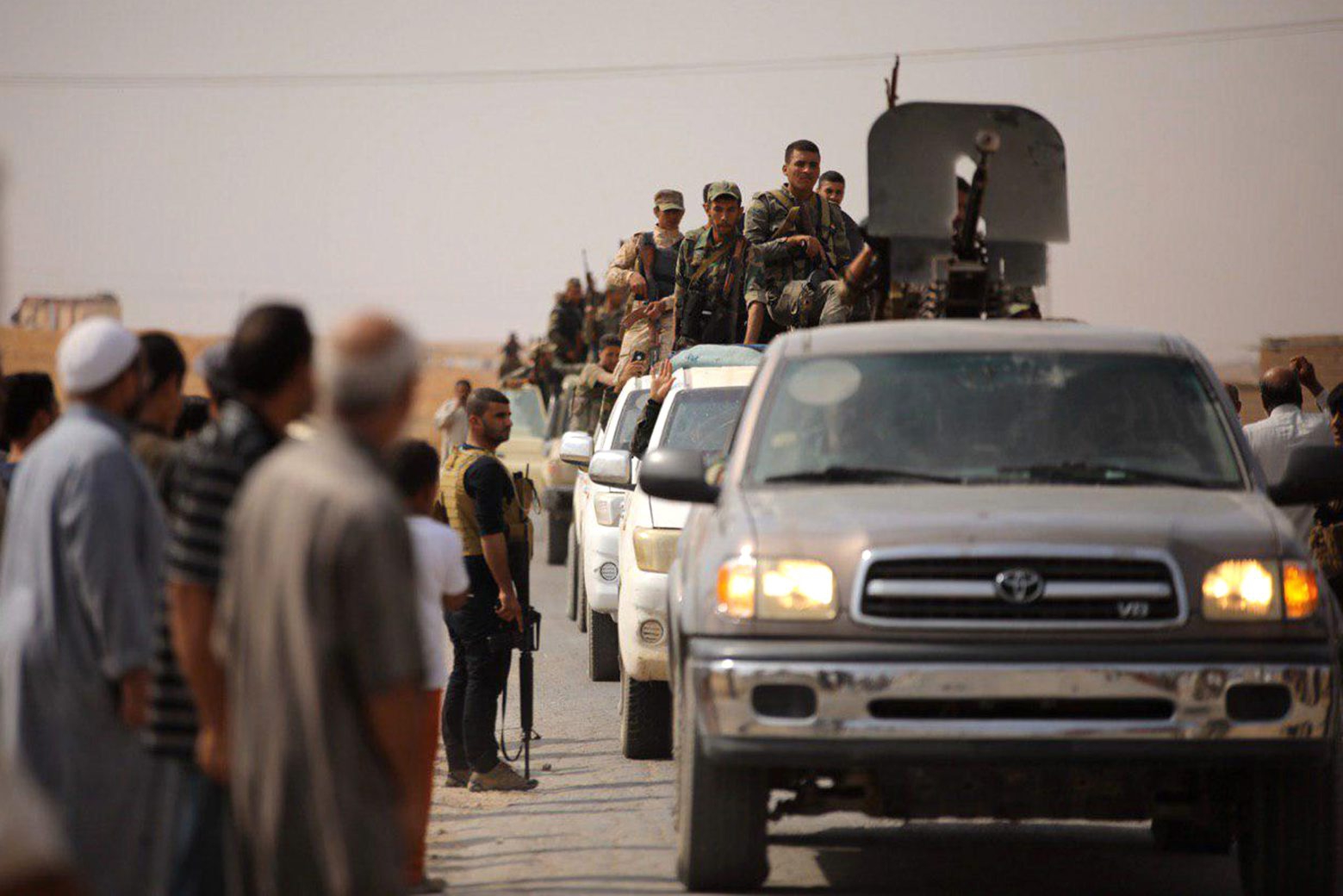 In this photo released by the Syrian official news agency SANA, Syrian troops enter the town of Ein Issa, north of Raqqa, Syria, Monday, Oct 14, 2019. Syrian troops moved east from Aleppo province to Raqqa where state media said they had reached Ein Issa. Heavy fighting the previous day there reached a Kurdish-run displaced-person camp that is home to some 12,000 people, including around 1,000 wives and widows of IS fighters and their children. Hundreds are believed to escaped amid the chaos. (SANA via AP) Syria