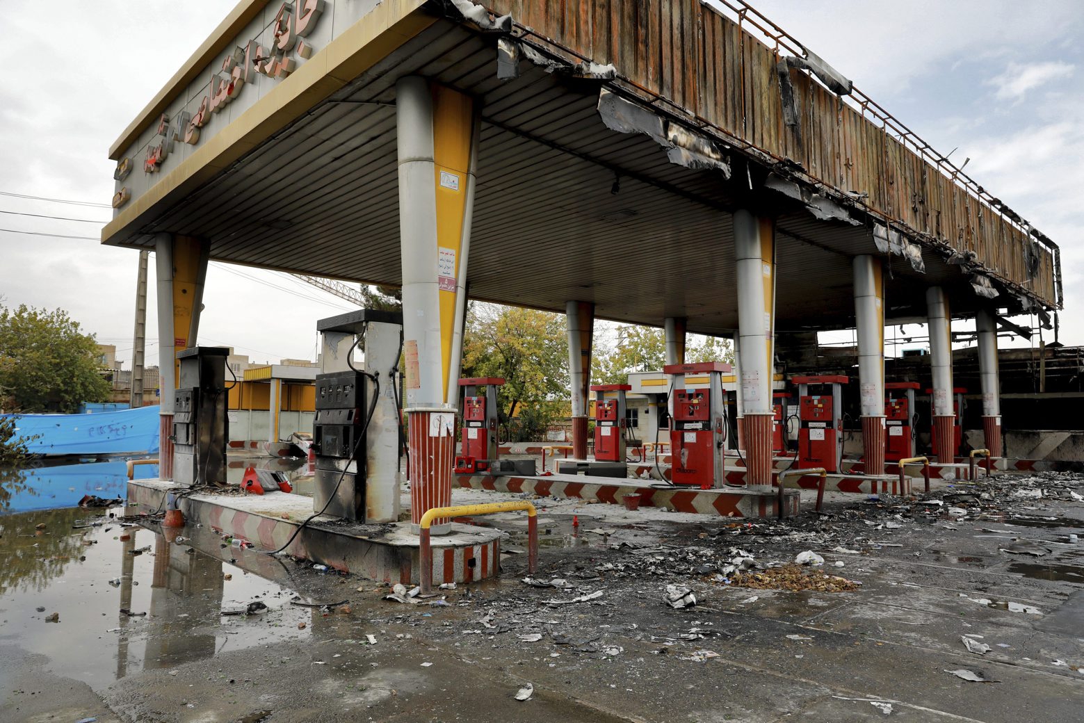 A gas station shows damages after it was attacked and burned during protests over rises in government-set gasoline prices, in Tehran, Iran, Wednesday, Nov. 20, 2019. Demonstrations struck at least 100 cities and towns, spiraling into violence that saw banks, stores and police stations attacked and burned. (AP Photo/Ebrahim Noroozi) Iran